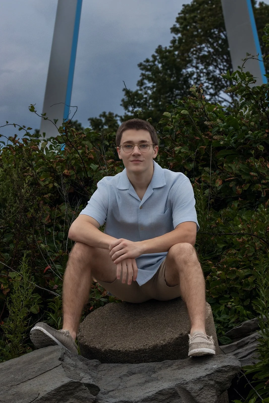 High School senior boy at Rocky Point State Park with iconic arch in the background.