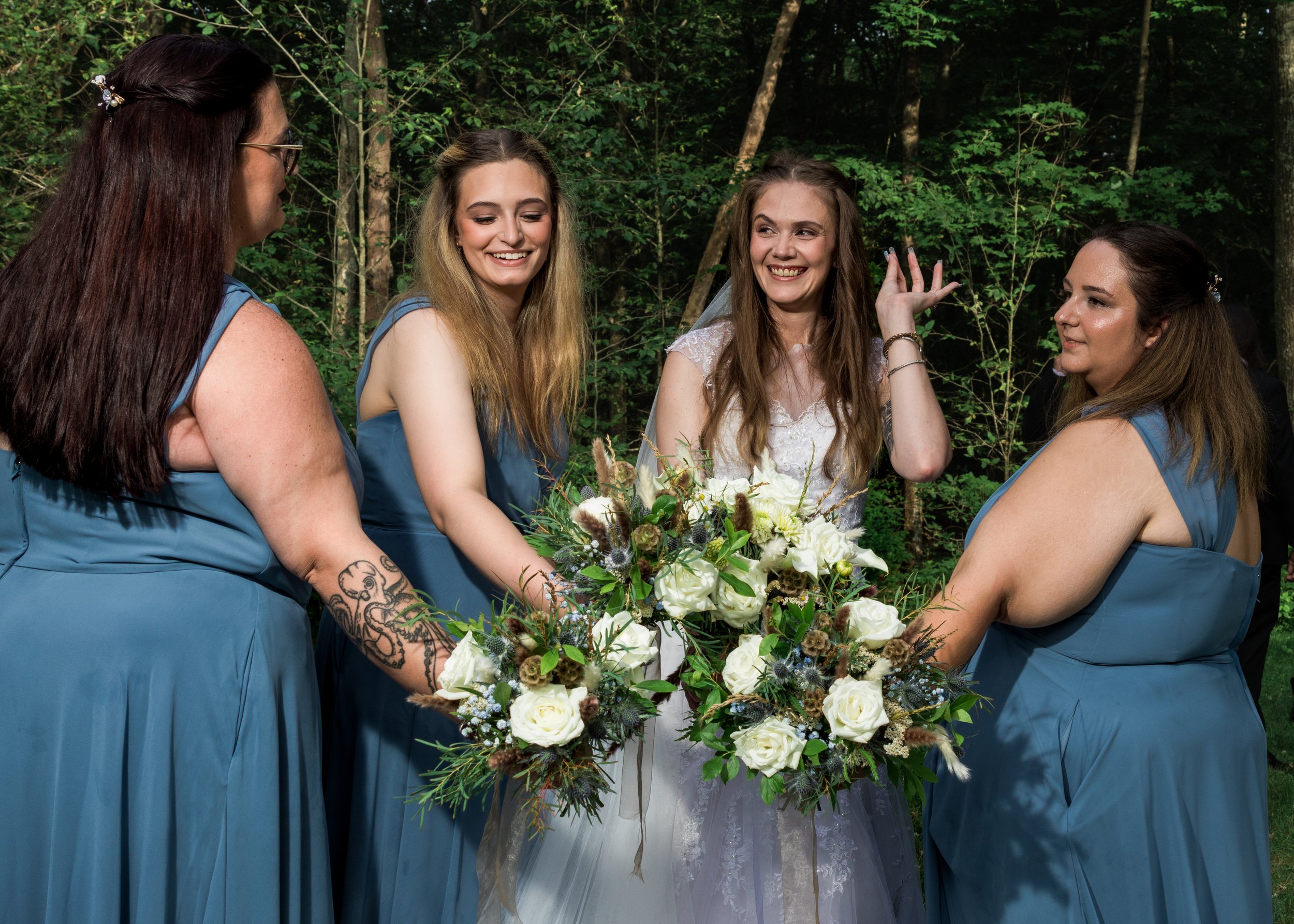 Bride and her bridal party showing off their flowers at Five Bridge Inn in Rehoboth, Massachusetts.
