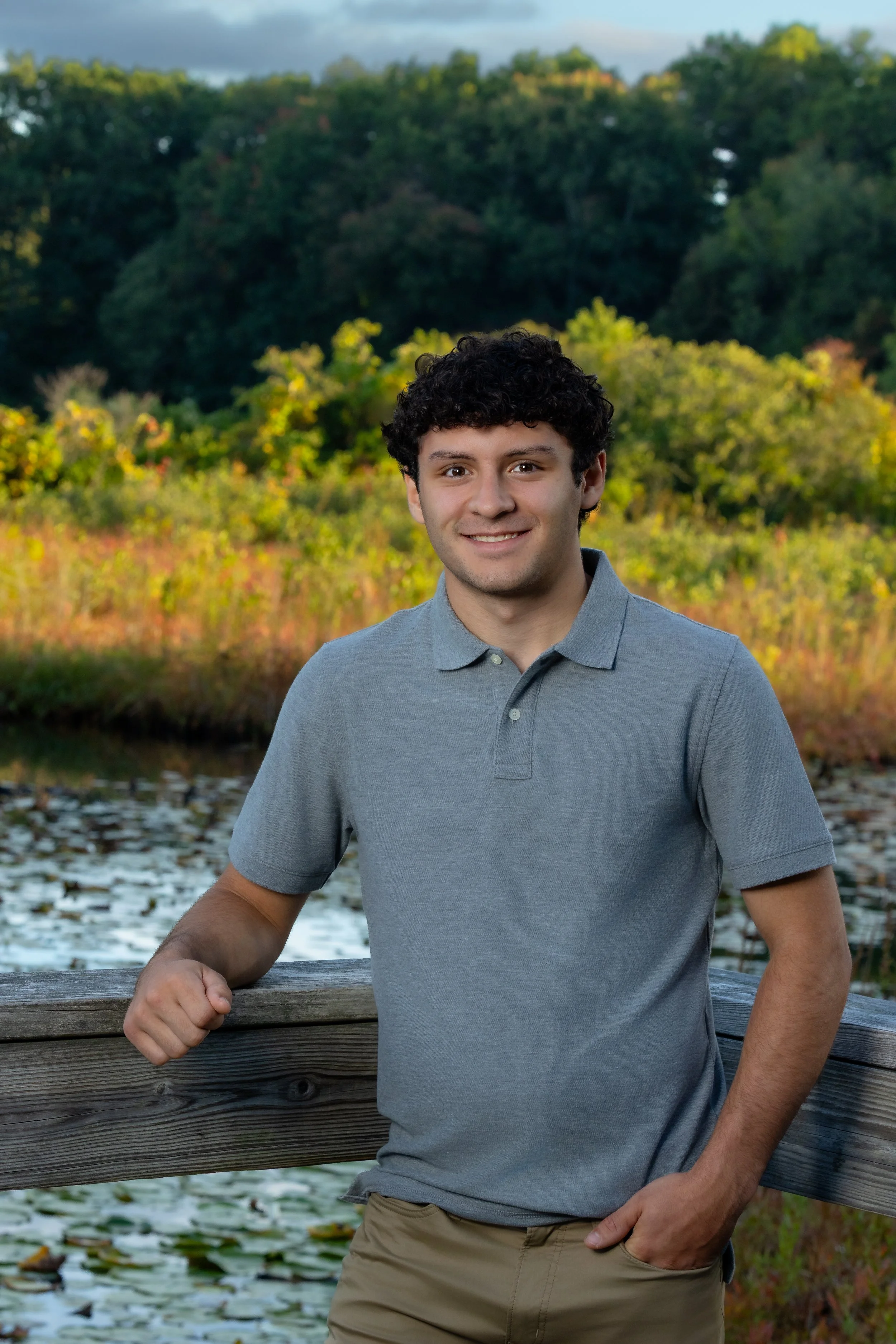 High school senior portrait of a boy outdoors by the water in Massachusetts