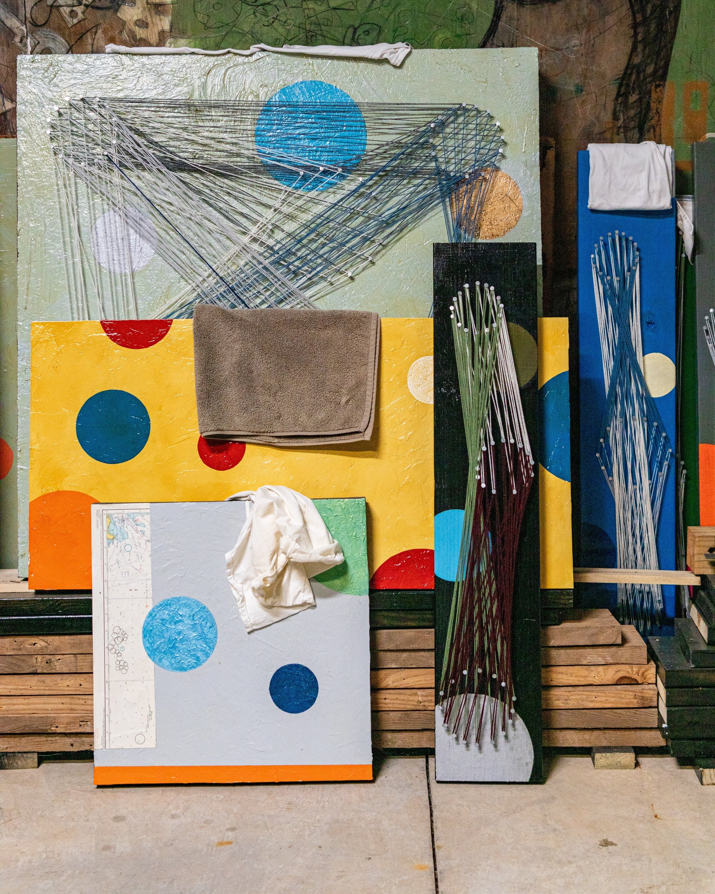 Colorful abstract art with circles and string on canvases