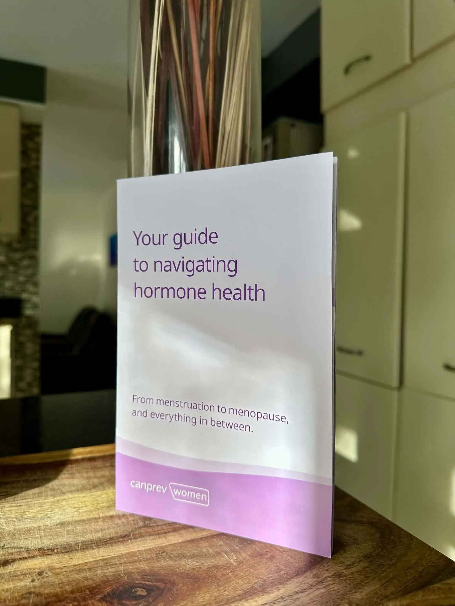 A booklet on top of a wooden cutting board