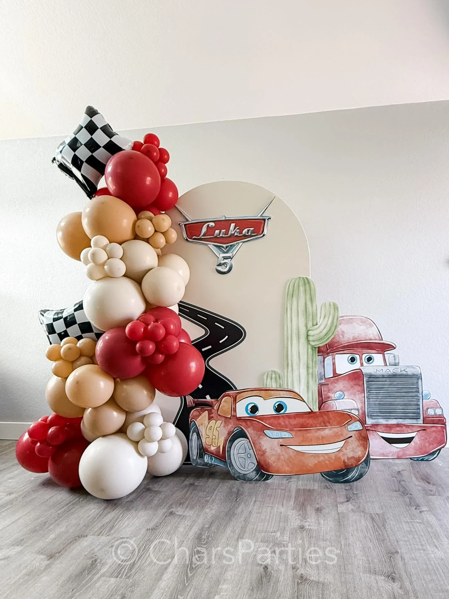 This is a Grab &amp; Go Package! 
Broken down into individual elements, it features a 6ft arch backdrop rental, custom logo name sign, vinyl road decal, 3 props: a cactus, Lightening McQueen, and Mack truck, with 7 feet of balloon garland + 2 special
