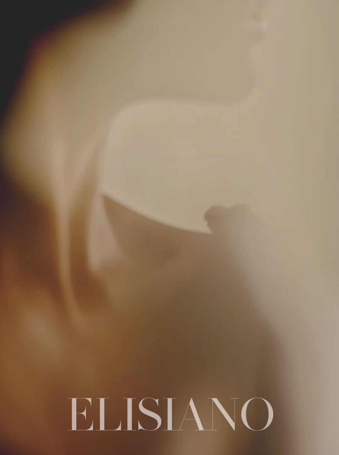 Close-up of a baby's face, with the name "ELISIANO" at the bottom.