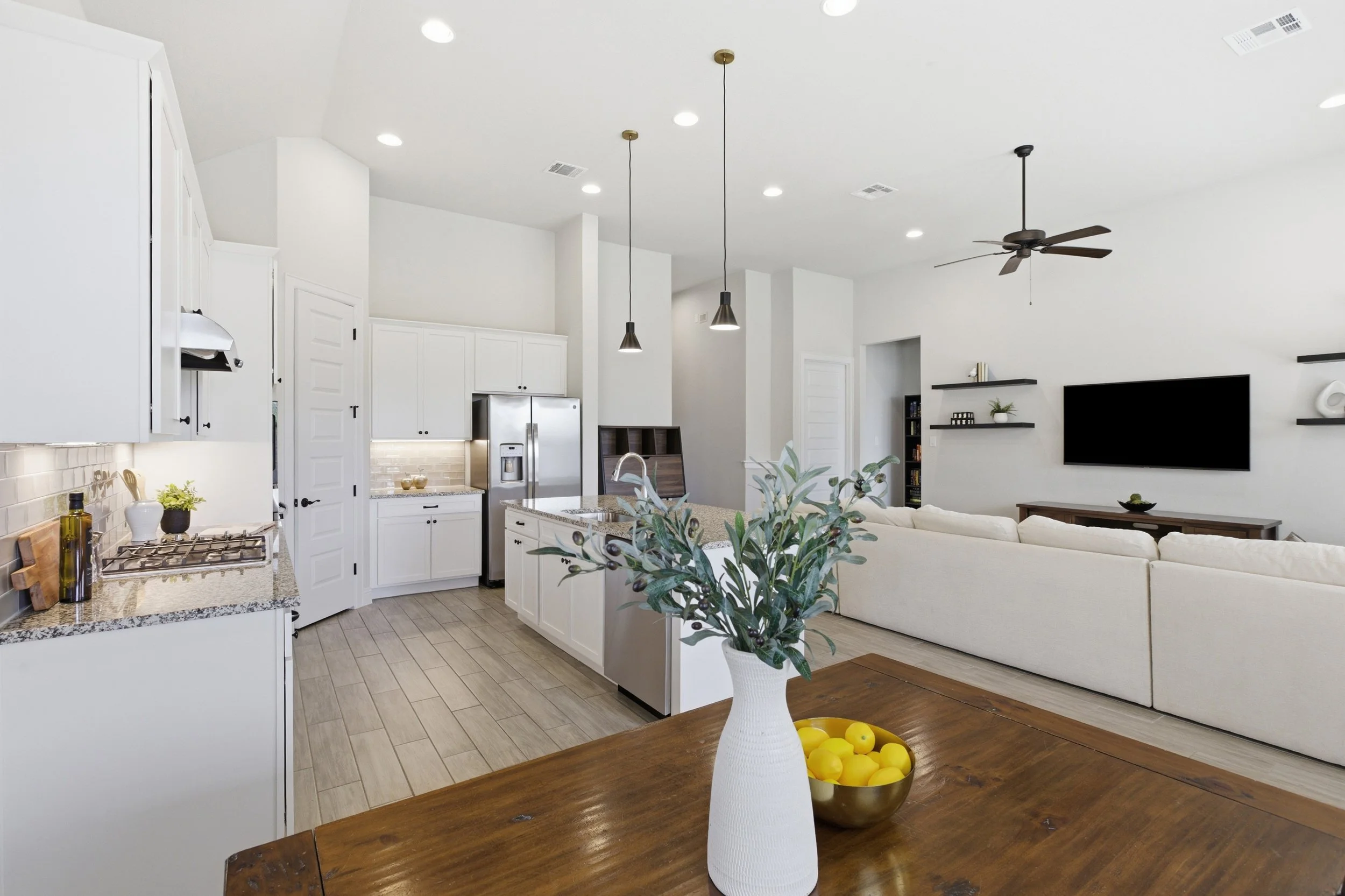 The kitchen features granite countertops, a large center island, built-in appliances, and a walk-in pantry | Georgetown, TX