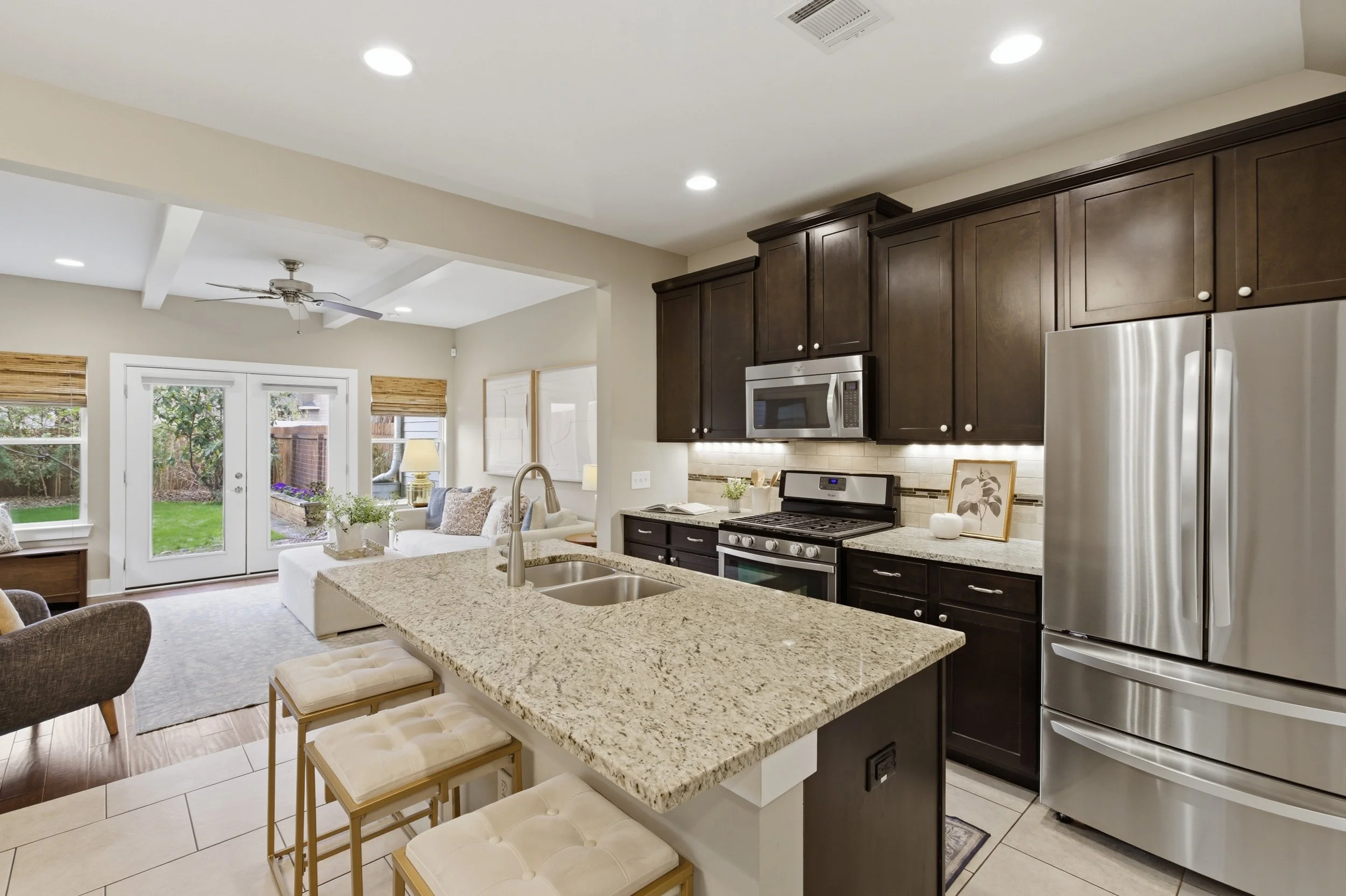 Modern kitchen with stainless steel appliances and eat-in island in Brentwood Austin Texas condo.”