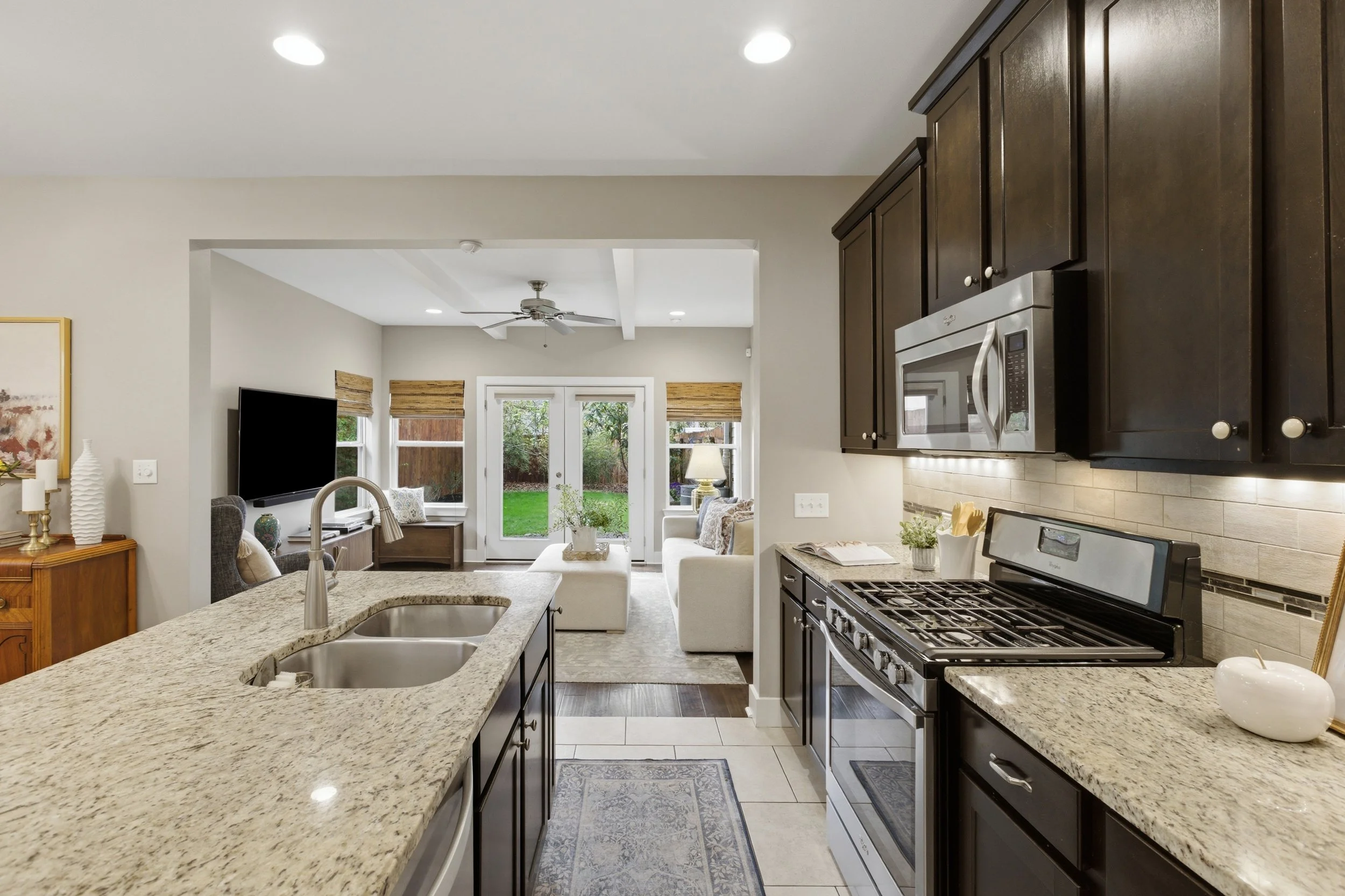 Modern kitchen with stainless steel appliances and eat-in island in Brentwood Austin Texas condo.”