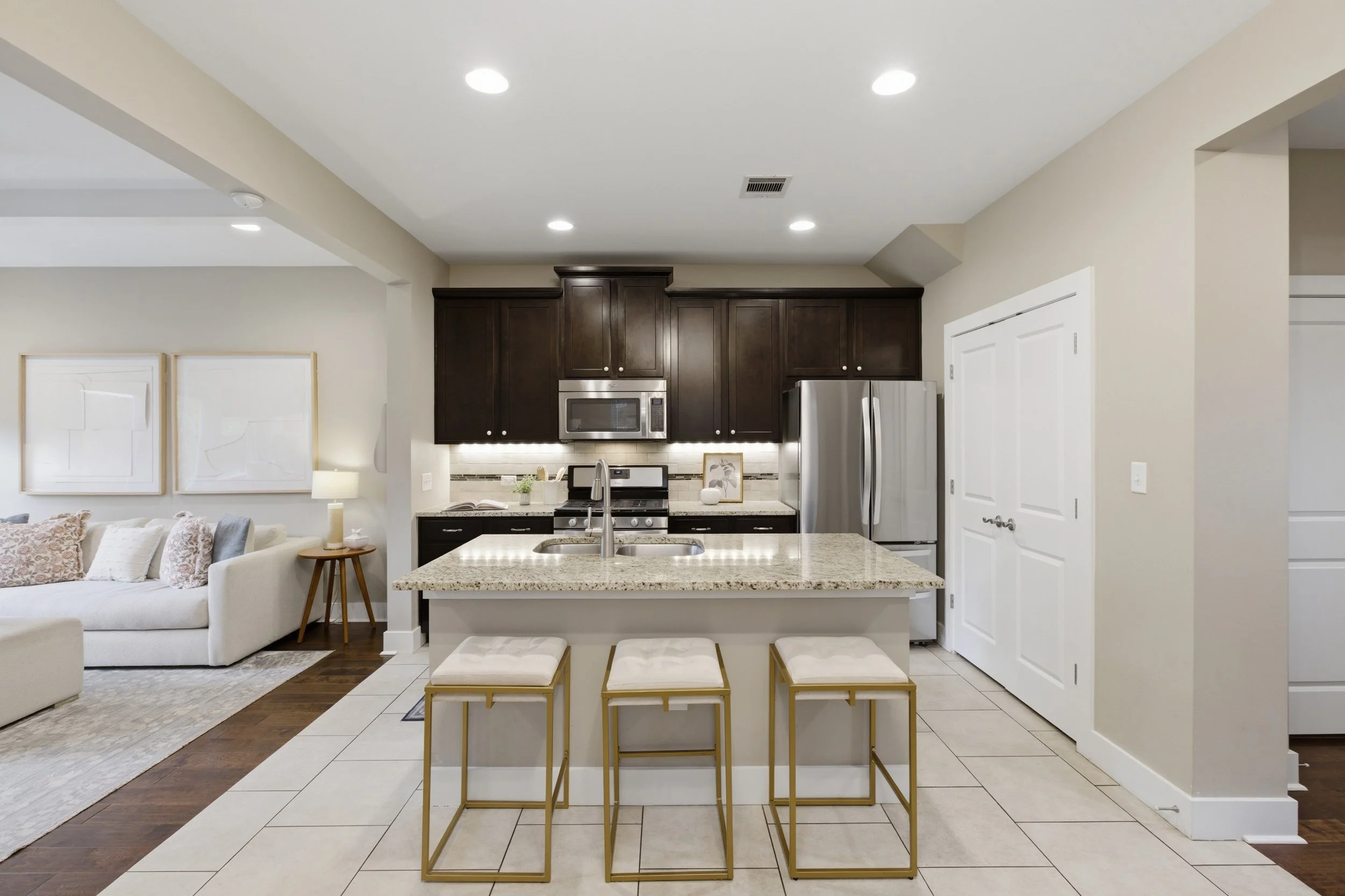 Modern kitchen with stainless steel appliances and eat-in island in Brentwood Austin Texas condo.”