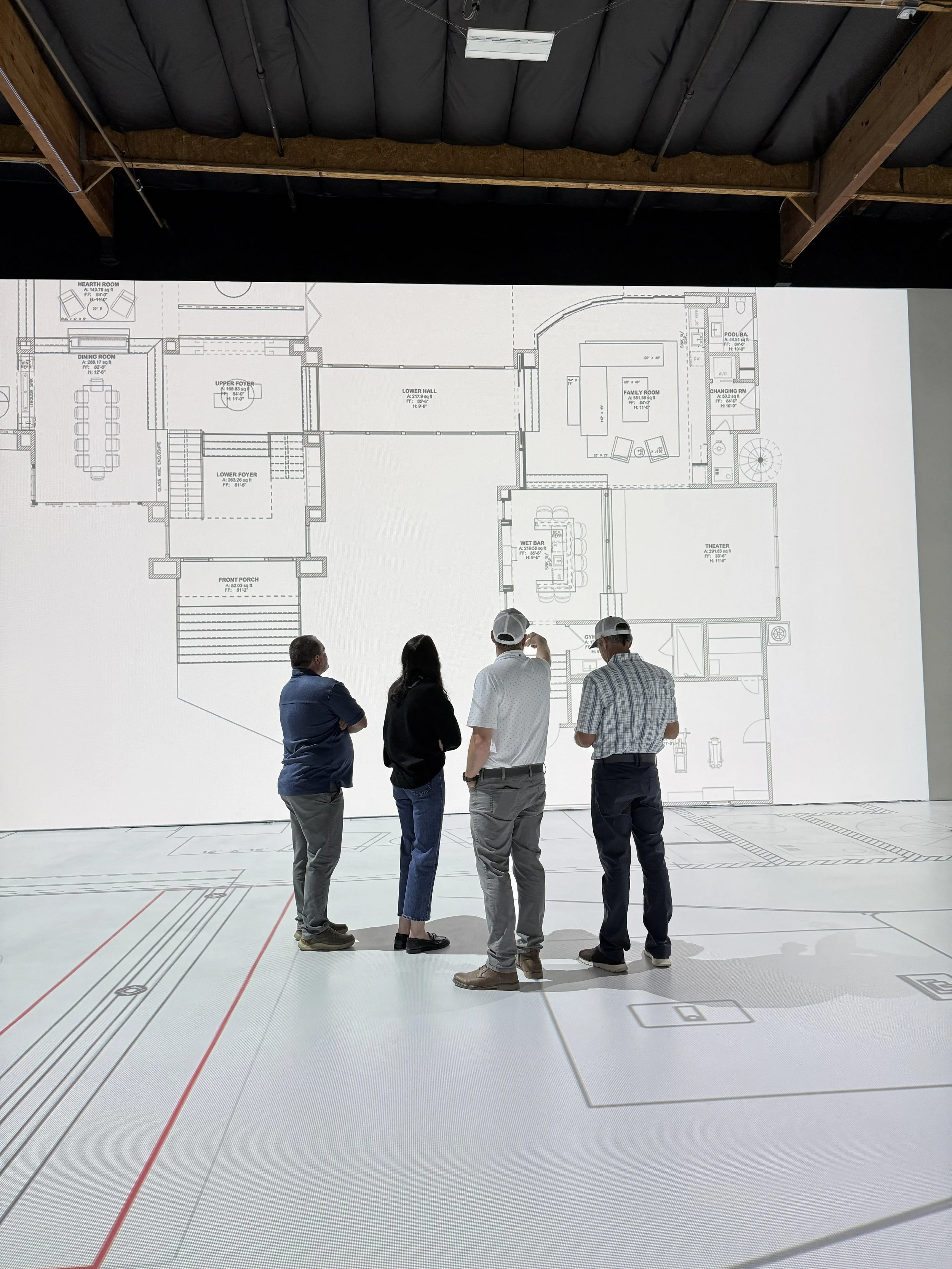 Builder and Clients Walking Life Size Plans