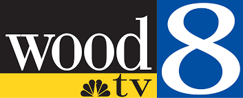 Wood TV 8 logo with black, yellow, and blue colors