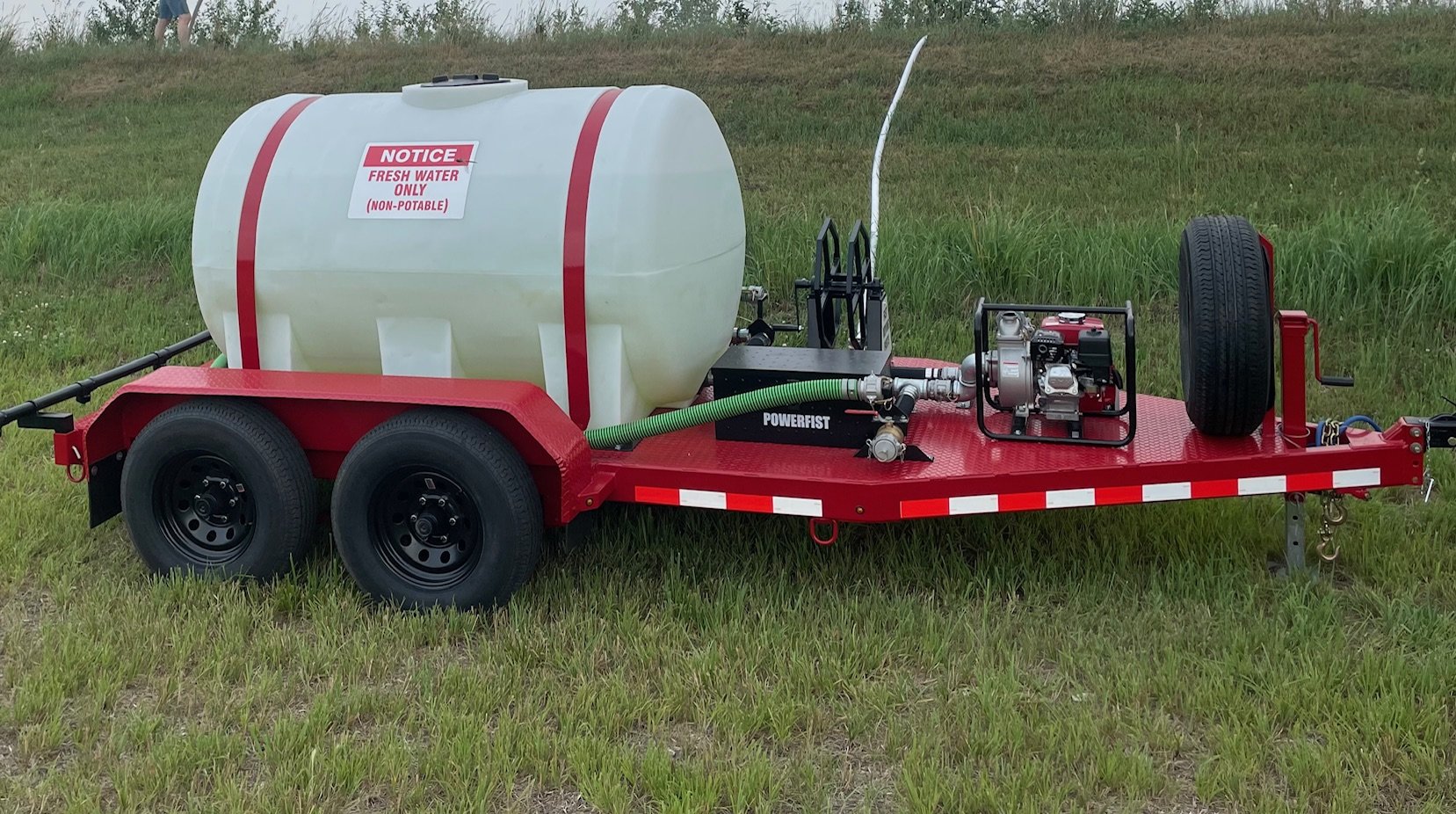 Trailer with a non-potable water tank on grass
