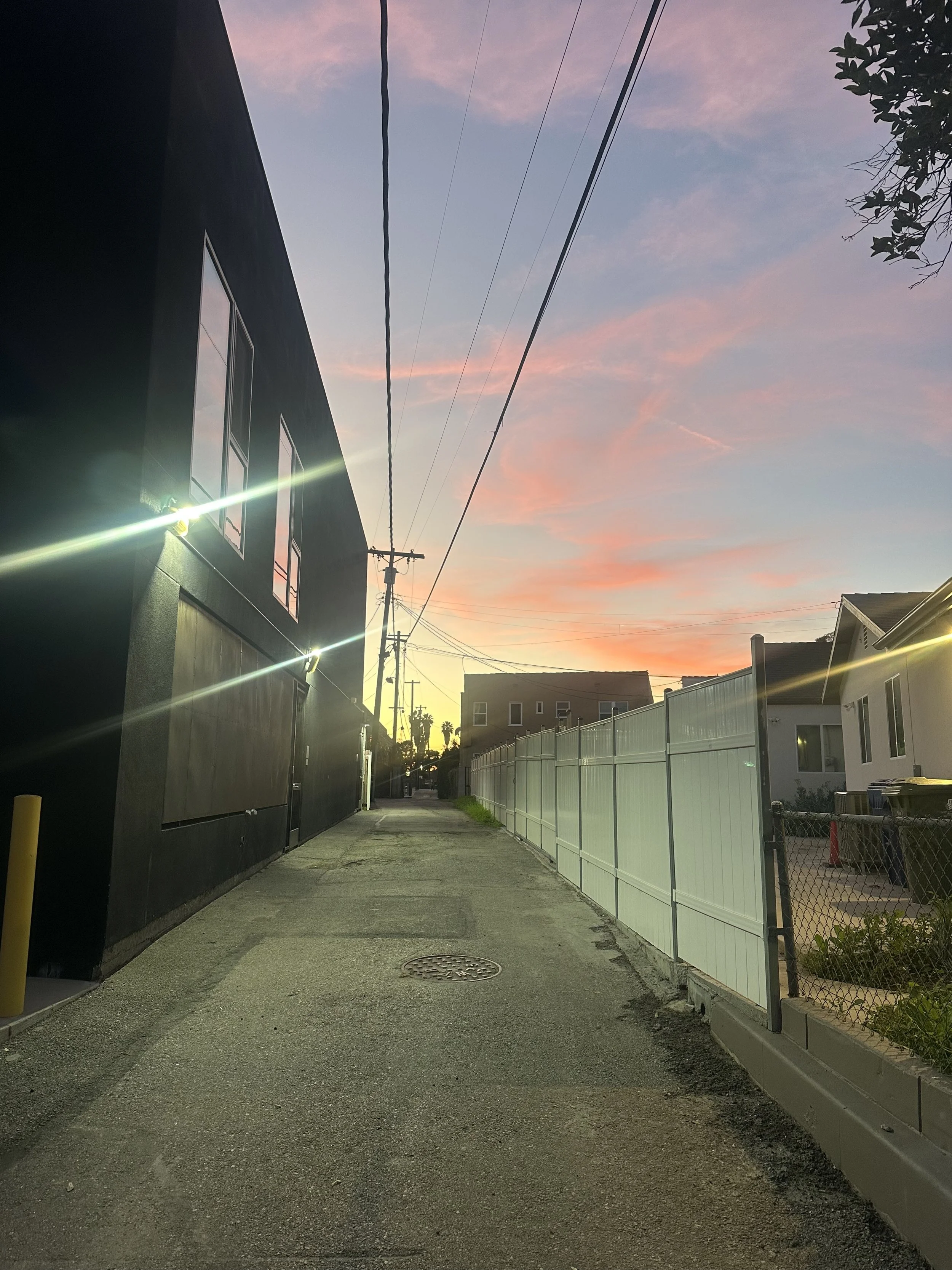 sunset over an alleyway street