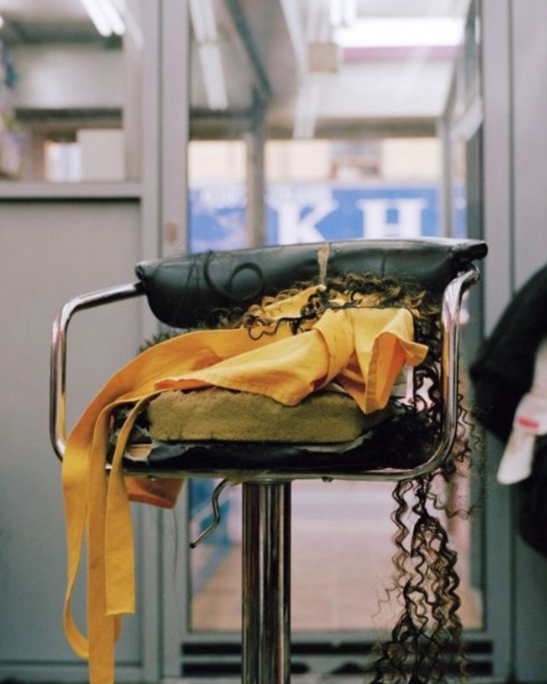 human hair and a cloth hanging off of a salon chair