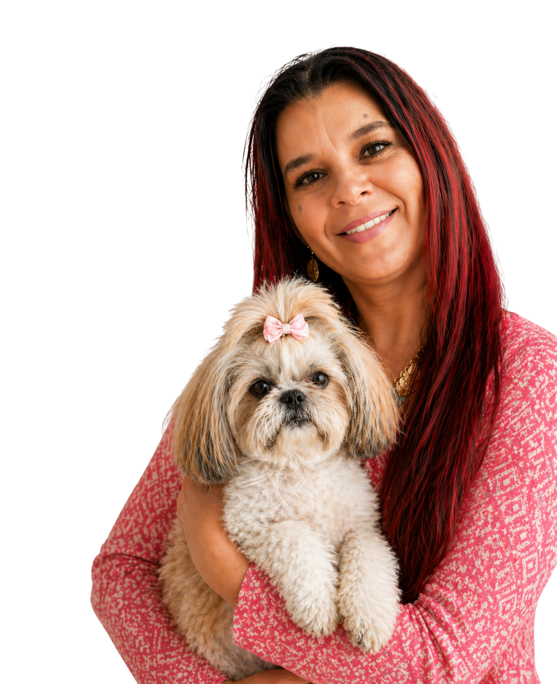 A woman with long red hair and a dog with a pink bow on its head, both smiling and looking at the camera.