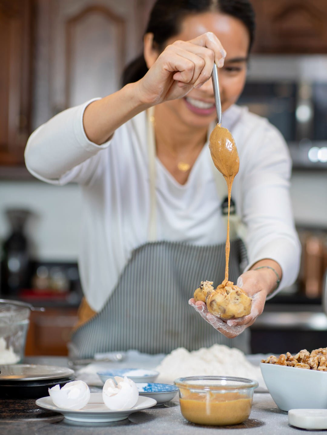 branding image of baker dripping peanut butter onto cookie