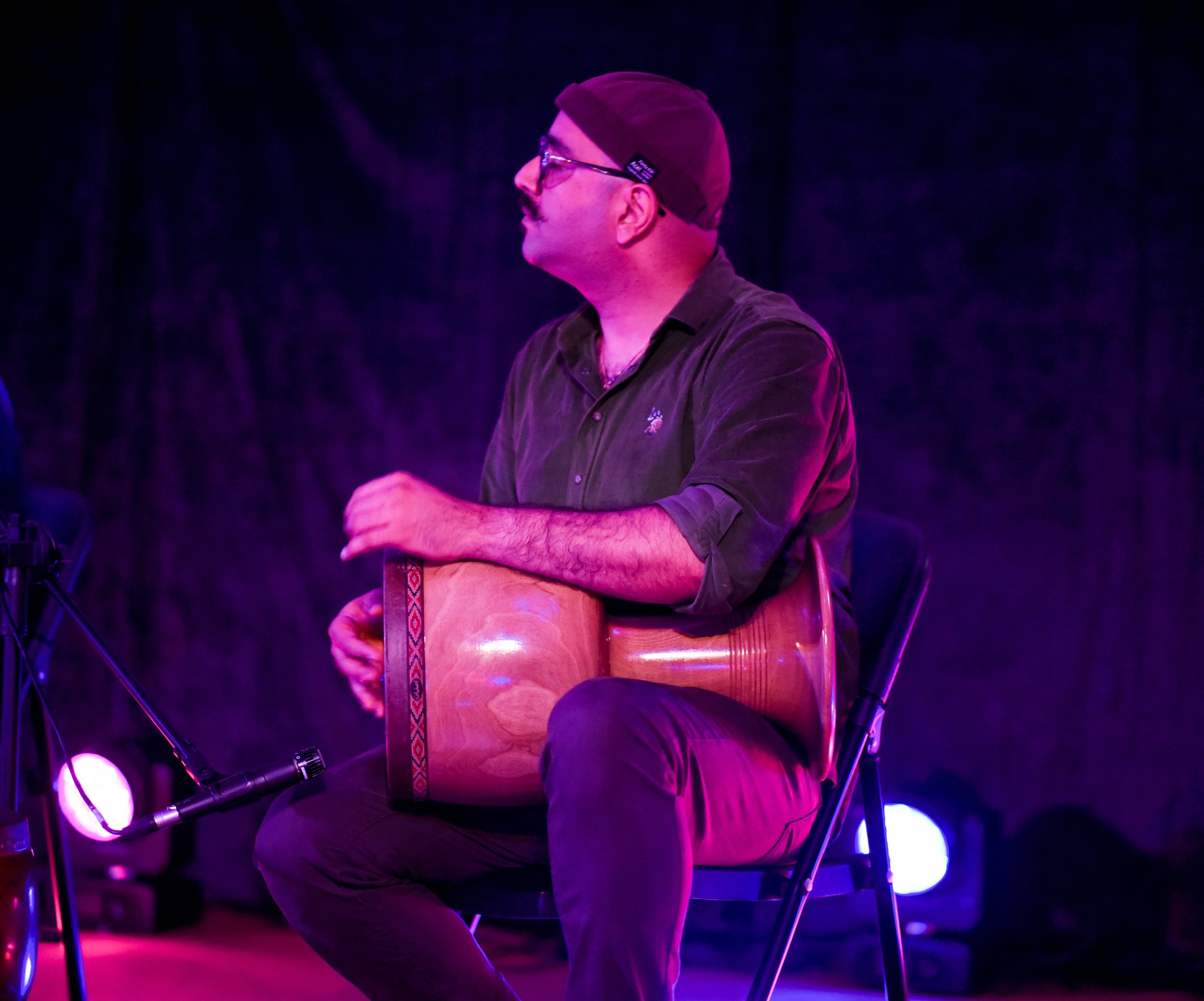 Person playing a goblet drum on stage