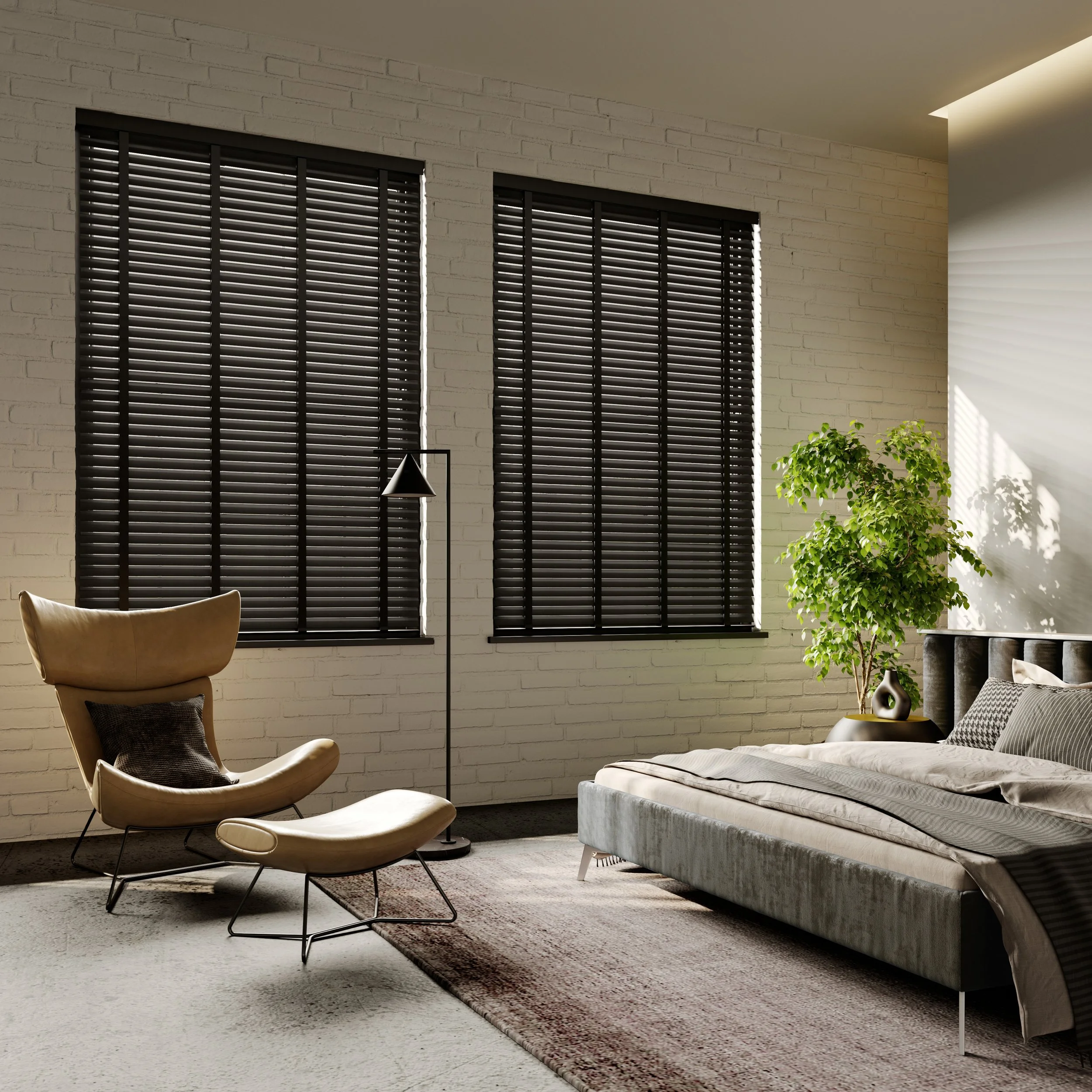 Modern bedroom with sleek furniture including a lounging chair with ottoman, a large bed, dark window blinds, a floor lamp, and indoor plants.