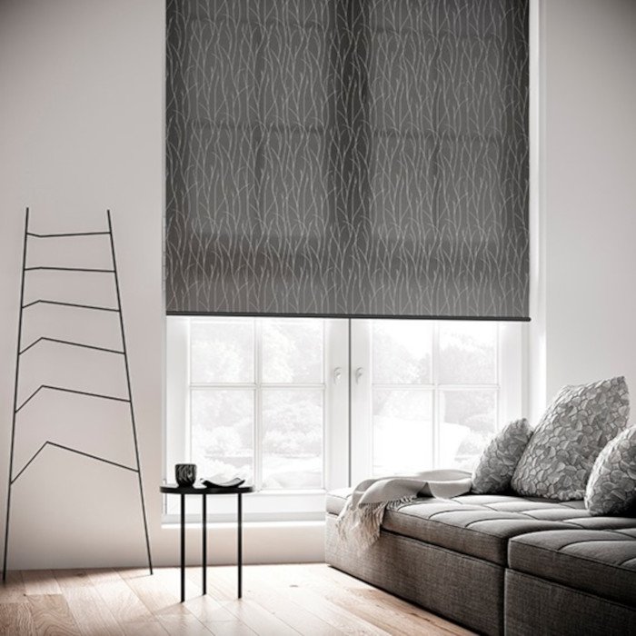 Modern living room with gray patterned roller blinds, gray sofa, decorative pillows, small black coffee table, and a minimalist ladder-style bookshelf.