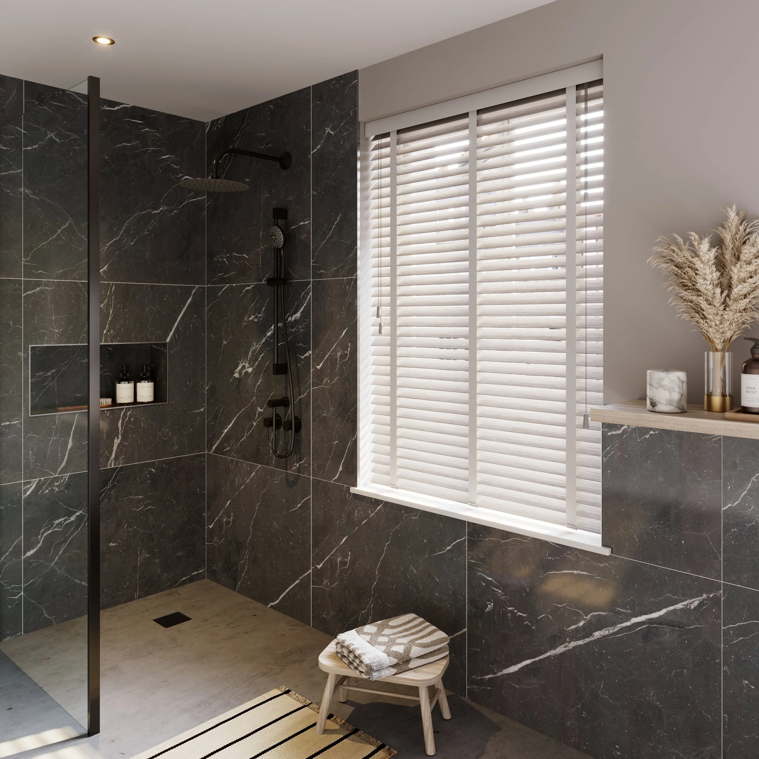 Modern bathroom with black marble tiles, glass shower door, window with white blinds, wooden stool with towel, pampas grass decor.