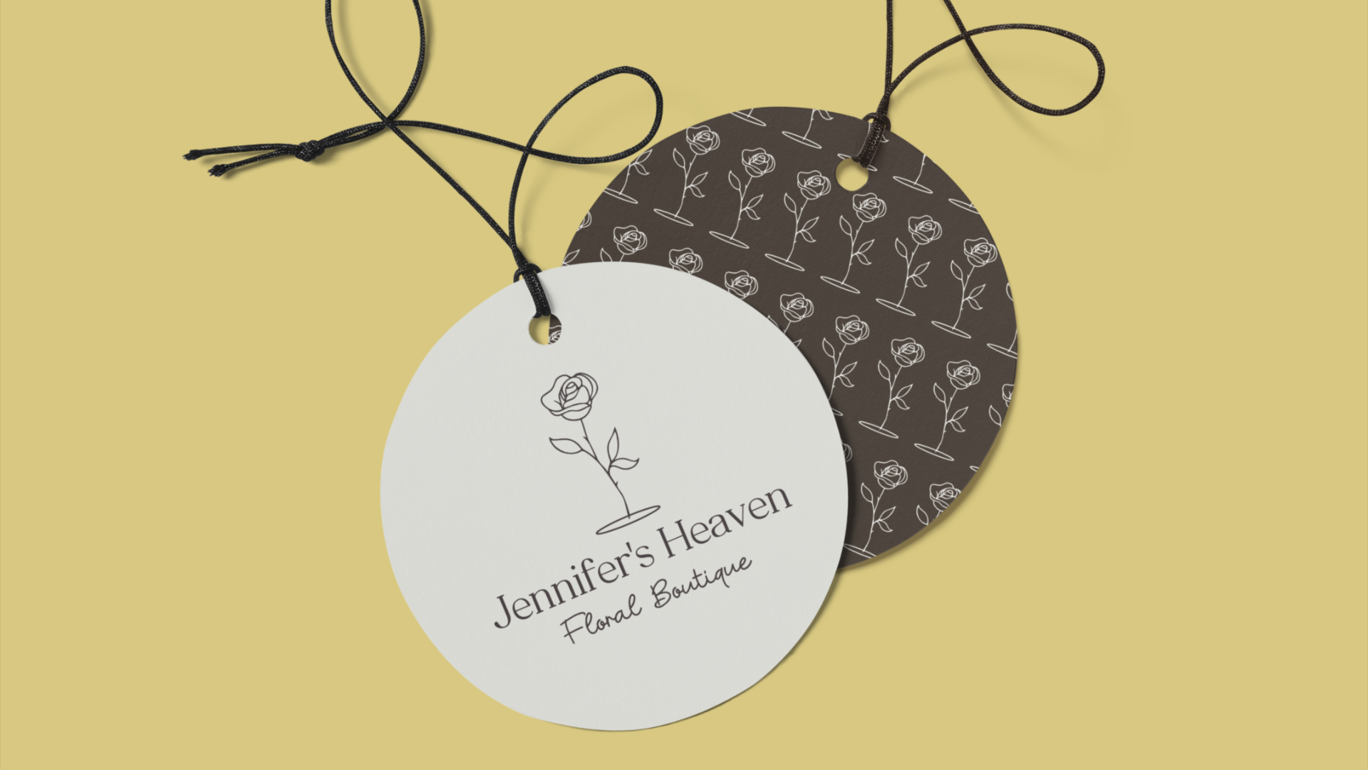 Three circular tags with floral patterns and a logo, attached by black strings, on a yellow background.