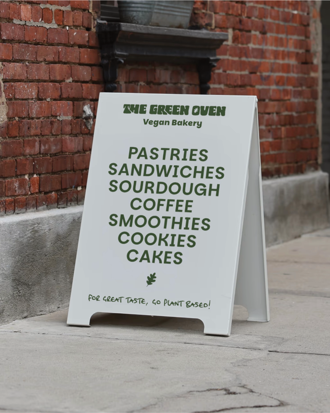 White branded A-board for The Green Oven with their logo and a list of items they sell