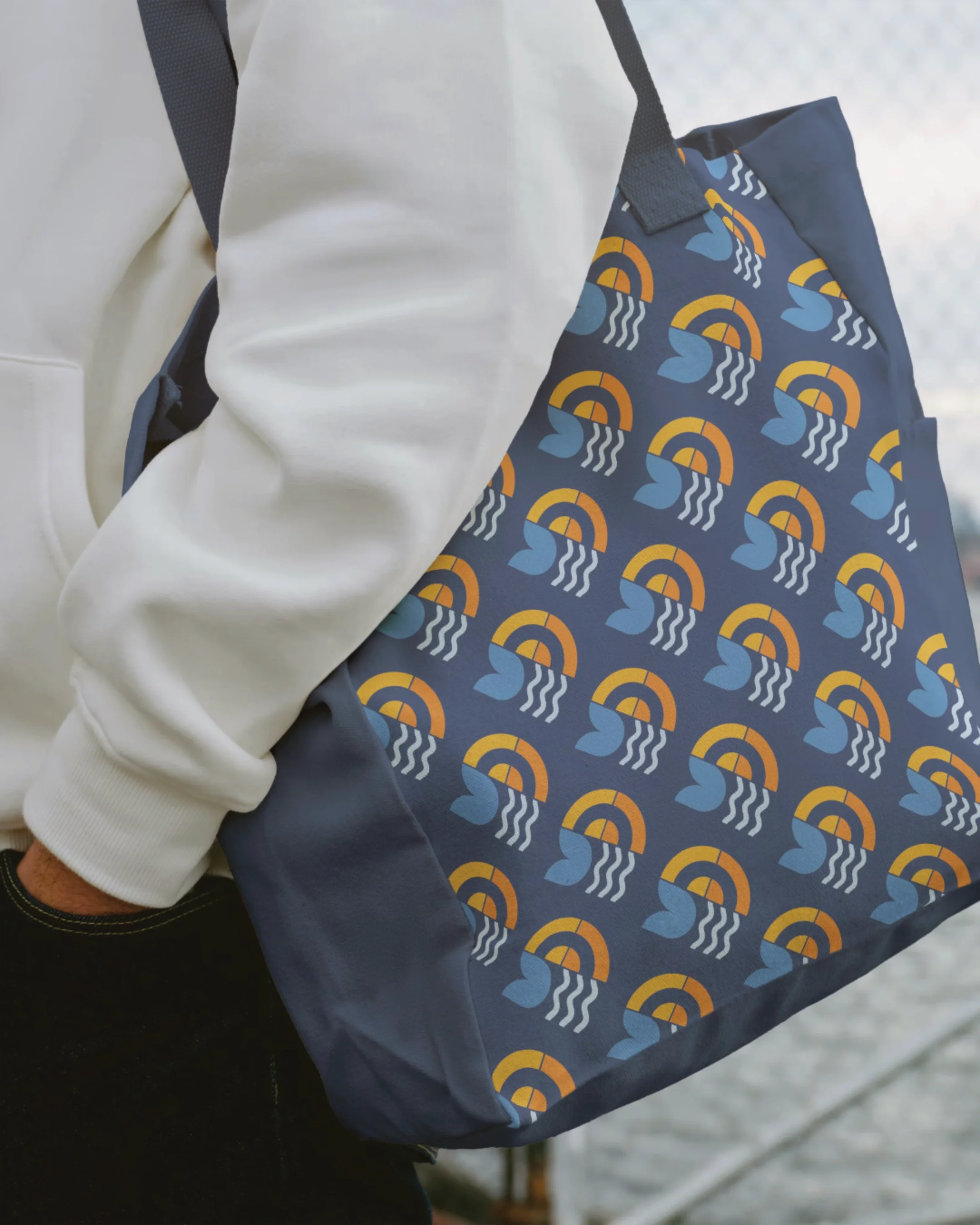A person carrying a blue backpack with a pattern of rainbows and water splashes.