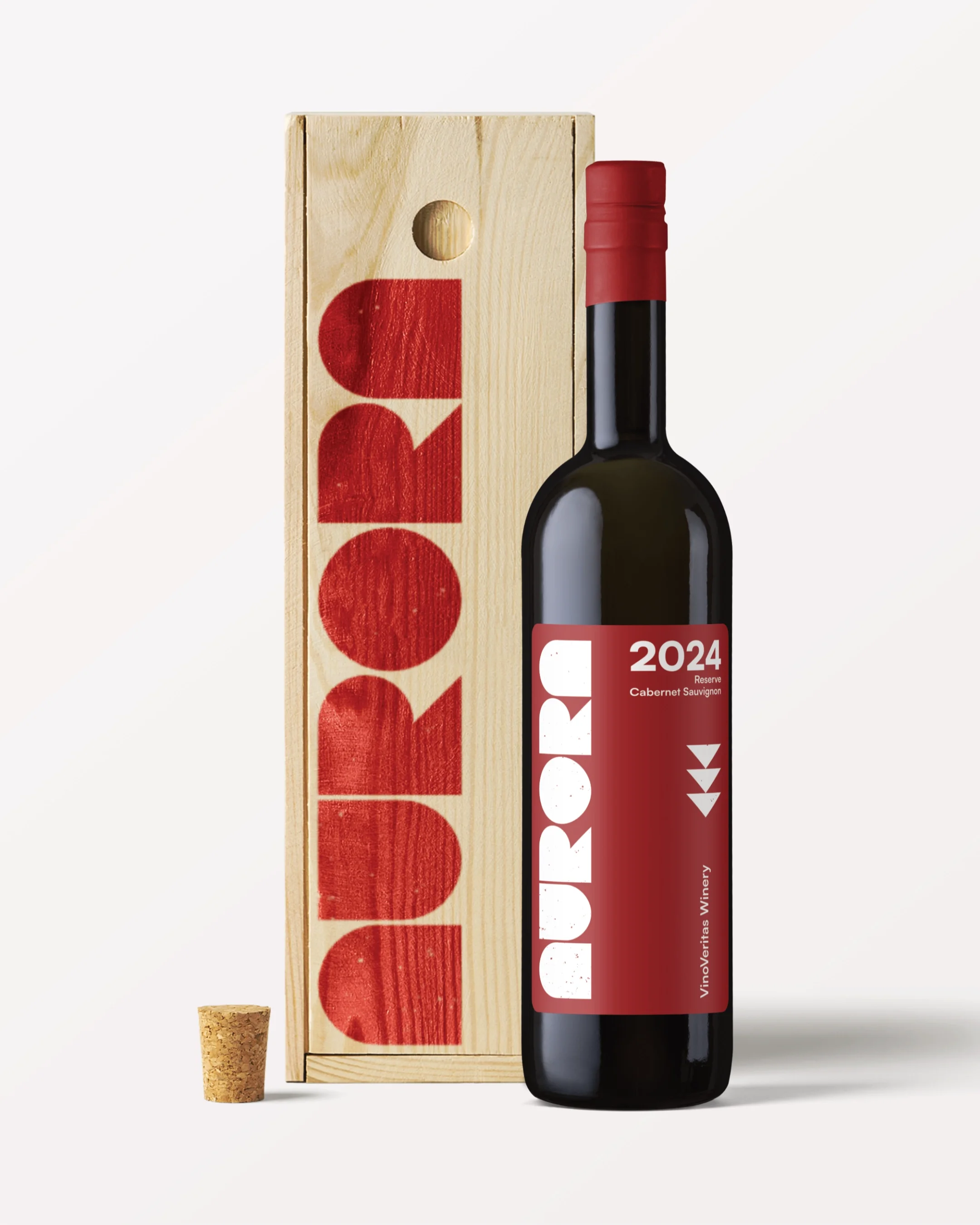 A bottle of wine with a red label reading '2024 Reserve Cabernet Sauvignon' placed beside a wooden box with the word 'Duro' printed in red, and a cork separated from the bottle.