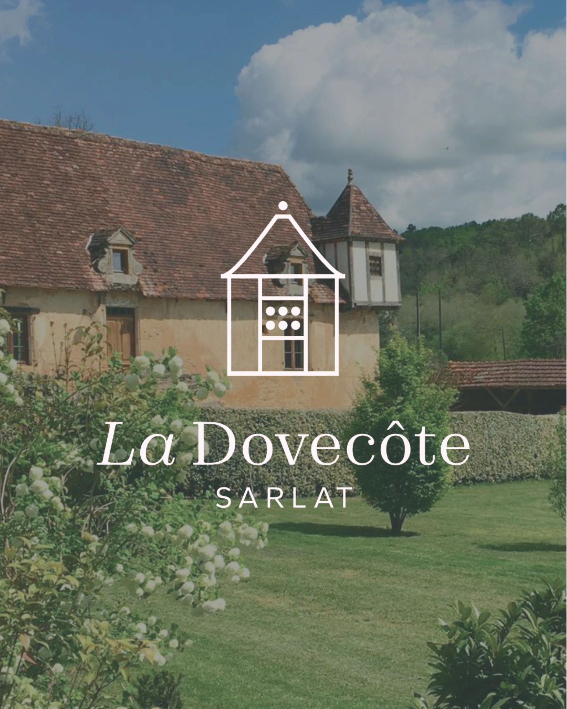 A scenic photo of a traditional European house with a red tiled roof, surrounded by green trees and shrubs under a partly cloudy sky, with a white line drawing of a house and the text "La Dovecôte Sarlat" overlayed.