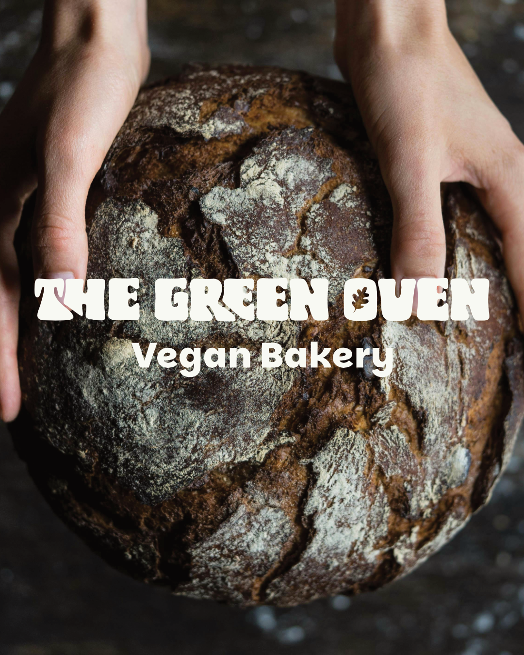 Image of a baked sourdough bread loaf being held, with the branding text for The Green Oven, Vegan Bakery