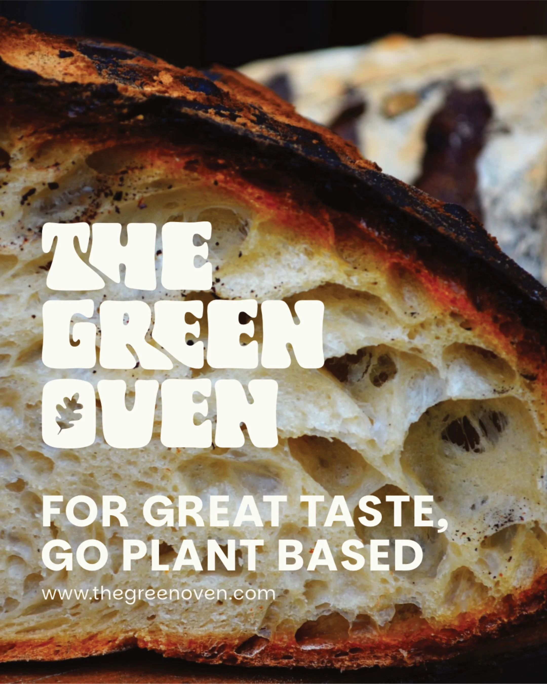Close-up of crusty bread with the text 'The Green Oven' and a caption promoting plant-based food for great taste.
