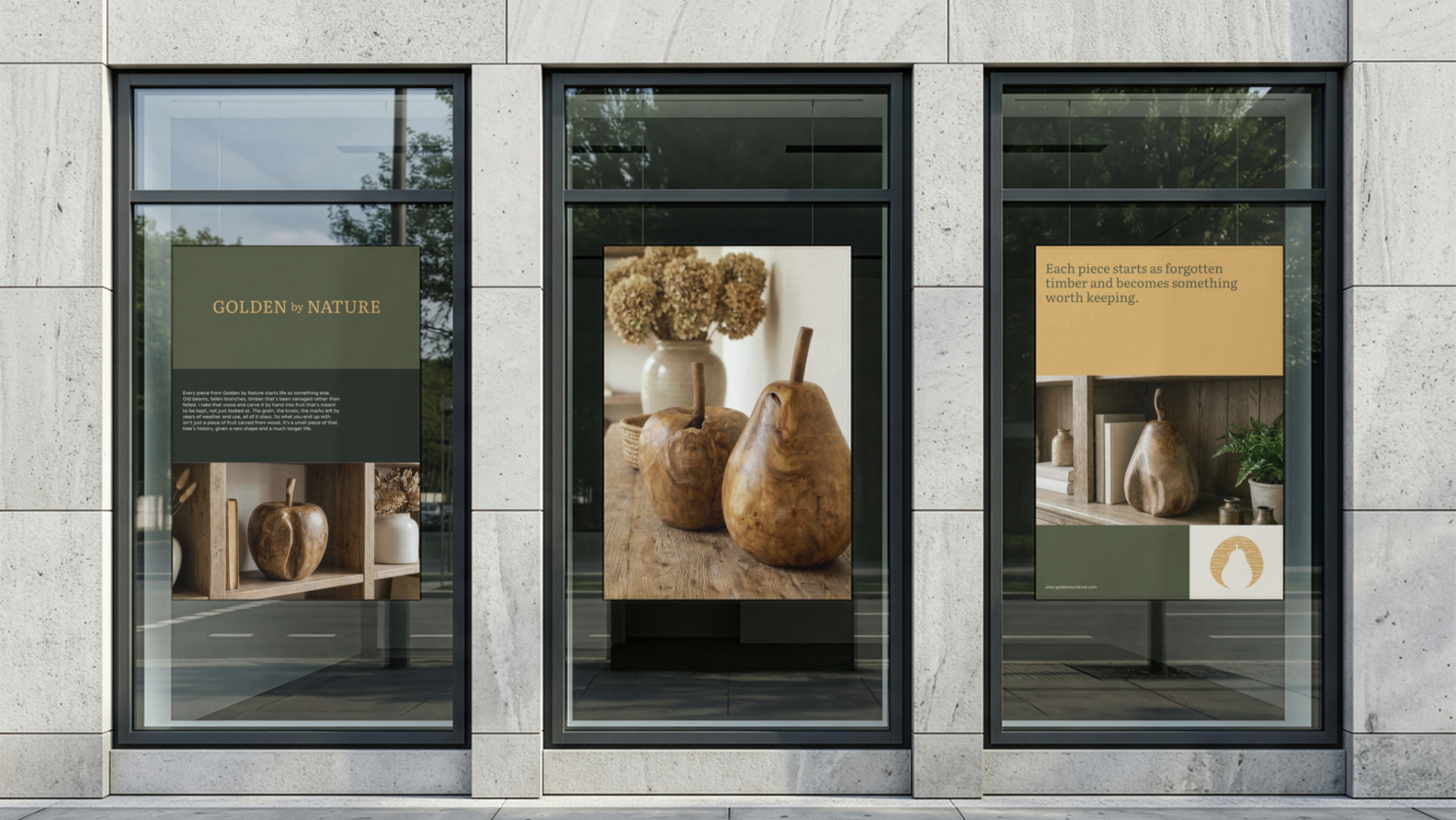 Storefront window display with wooden apple sculptures, framed artwork of flowers, and an informational sign about nature and craftsmanship.