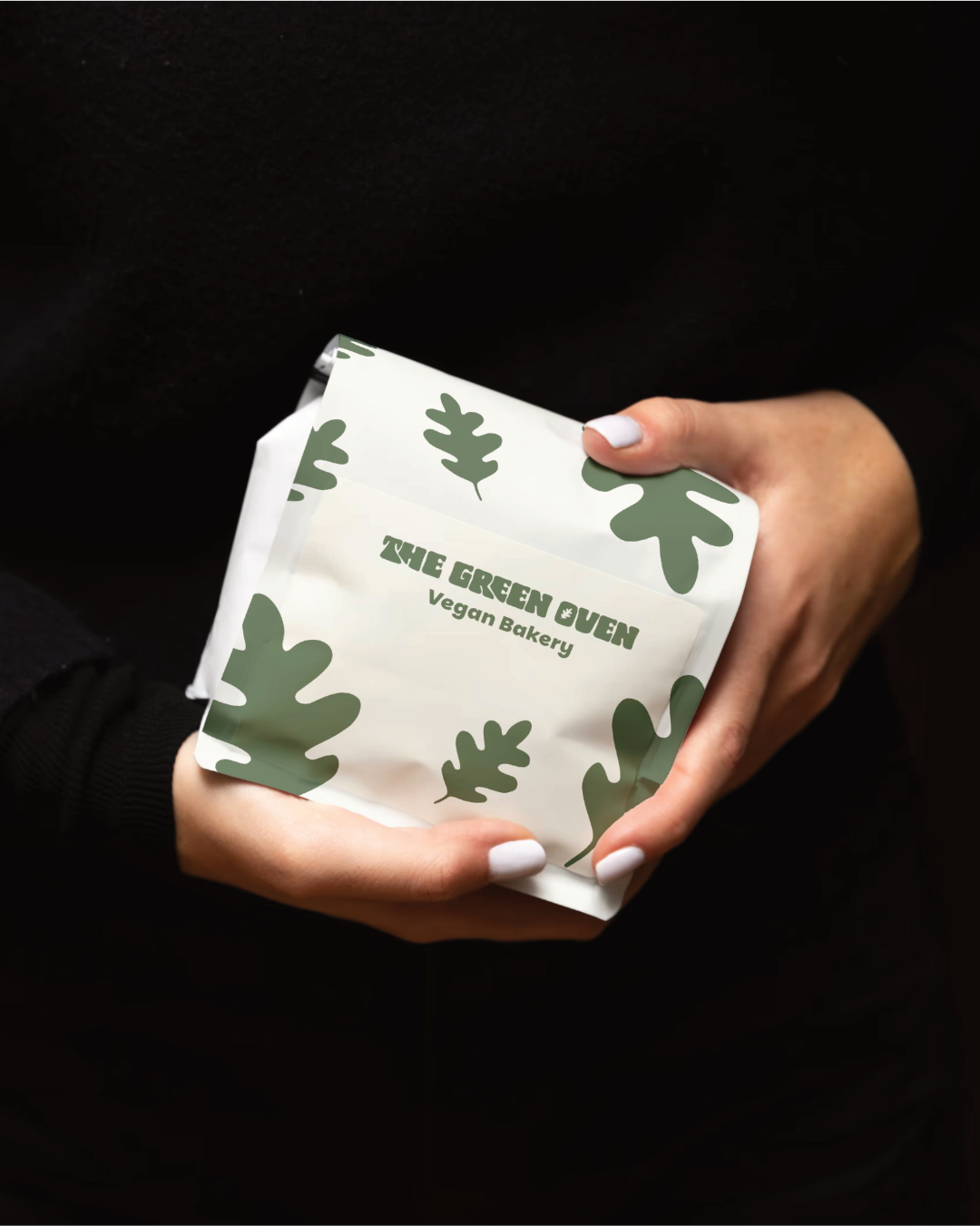 The Green Oven branded packaging being held