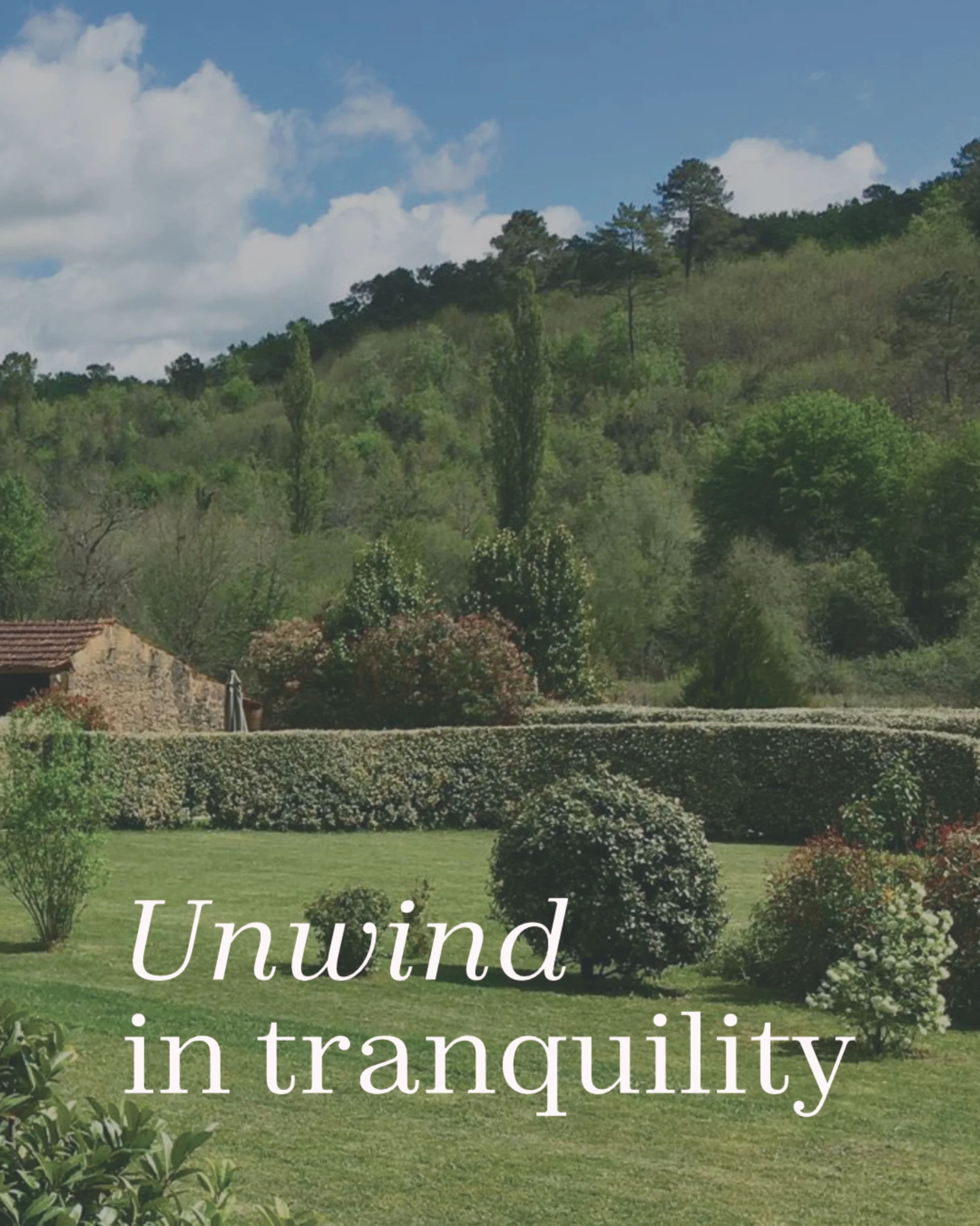 A peaceful garden scene with trimmed bushes, green grass, and trees, with a hill and a partly cloudy sky in the background. The words 'Unwind in tranquility' are overlaid on the image.
