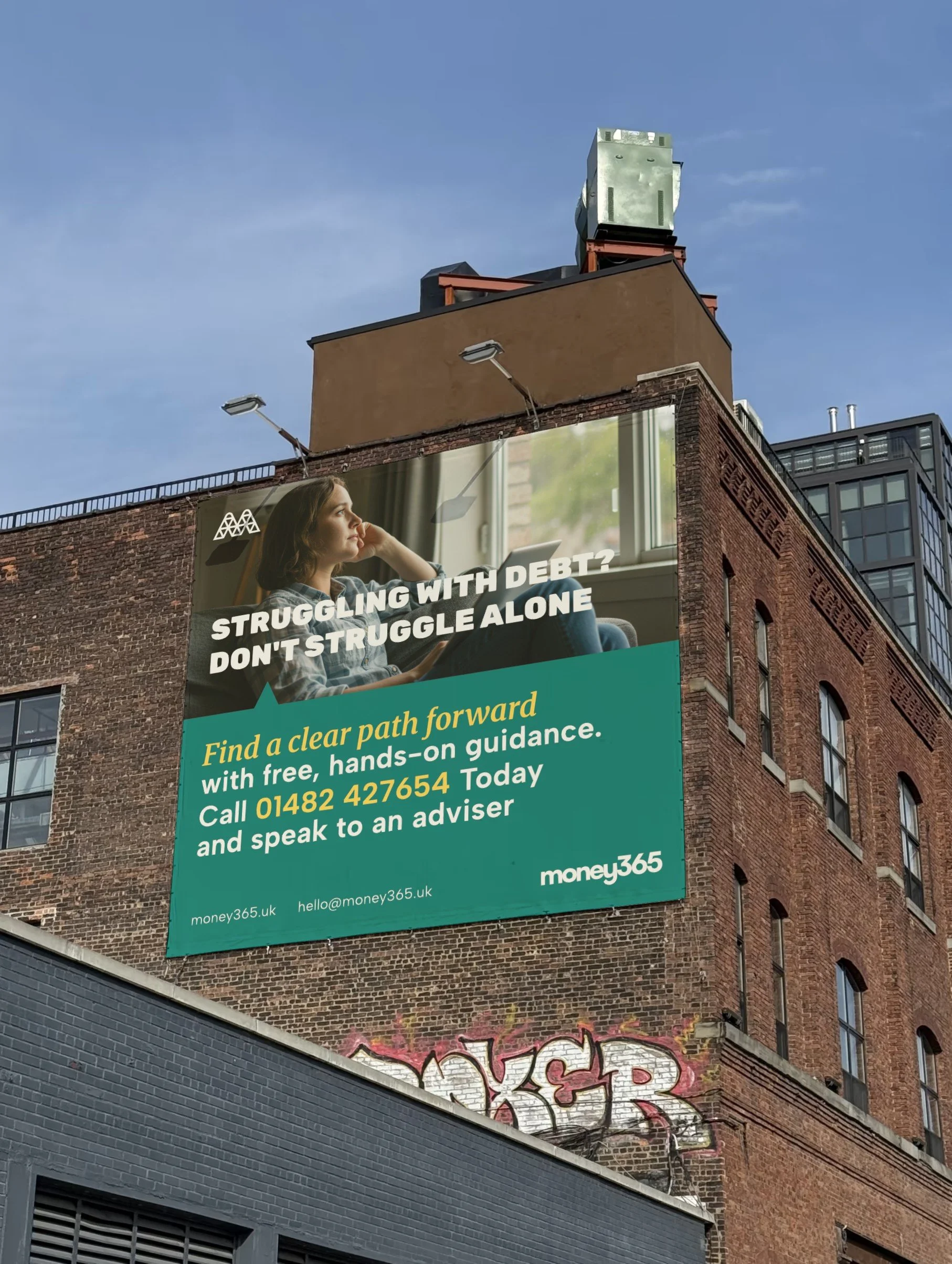 Bill board advertisement for Money365 positioned on the side of brick building wall