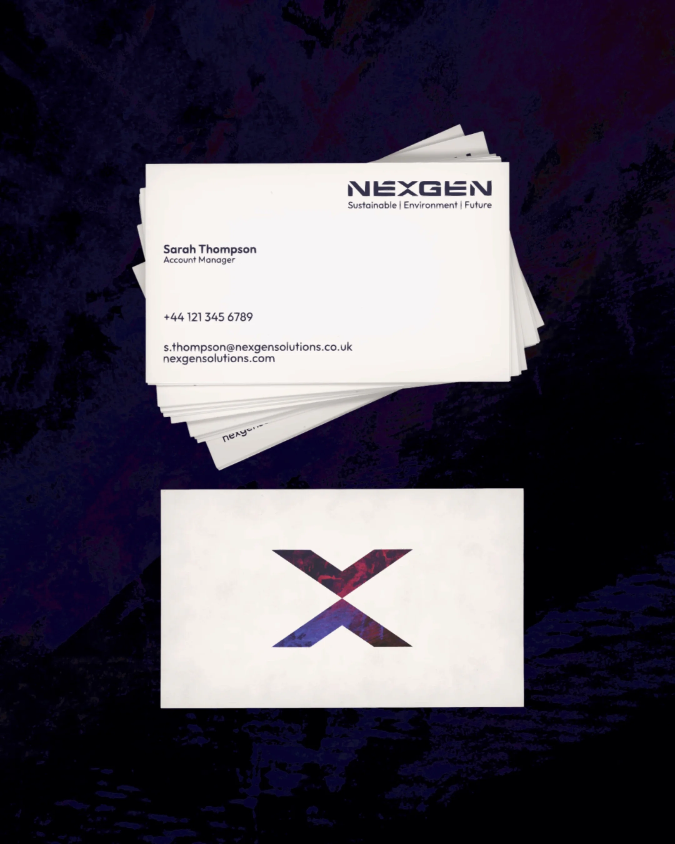 Stack of business cards for NEXGEN Solutions with a logo featuring a stylized 'X' on a white background, placed on a dark surface.