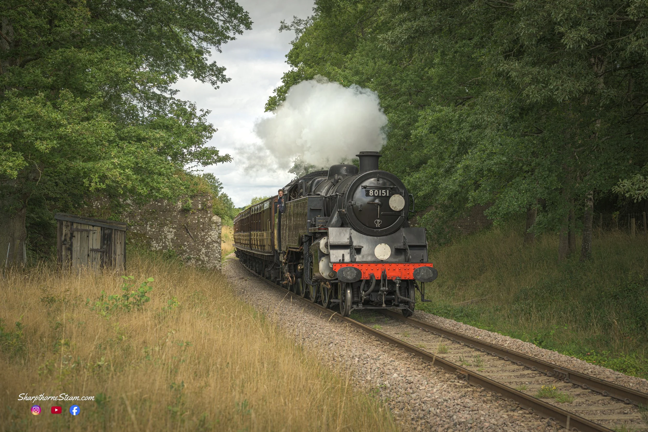 Branchline Working - No80151 with the vintage stock races south to Sheffield Park. The locomotive is photographed at the now demolished Town House Bridge. (Aug'25)