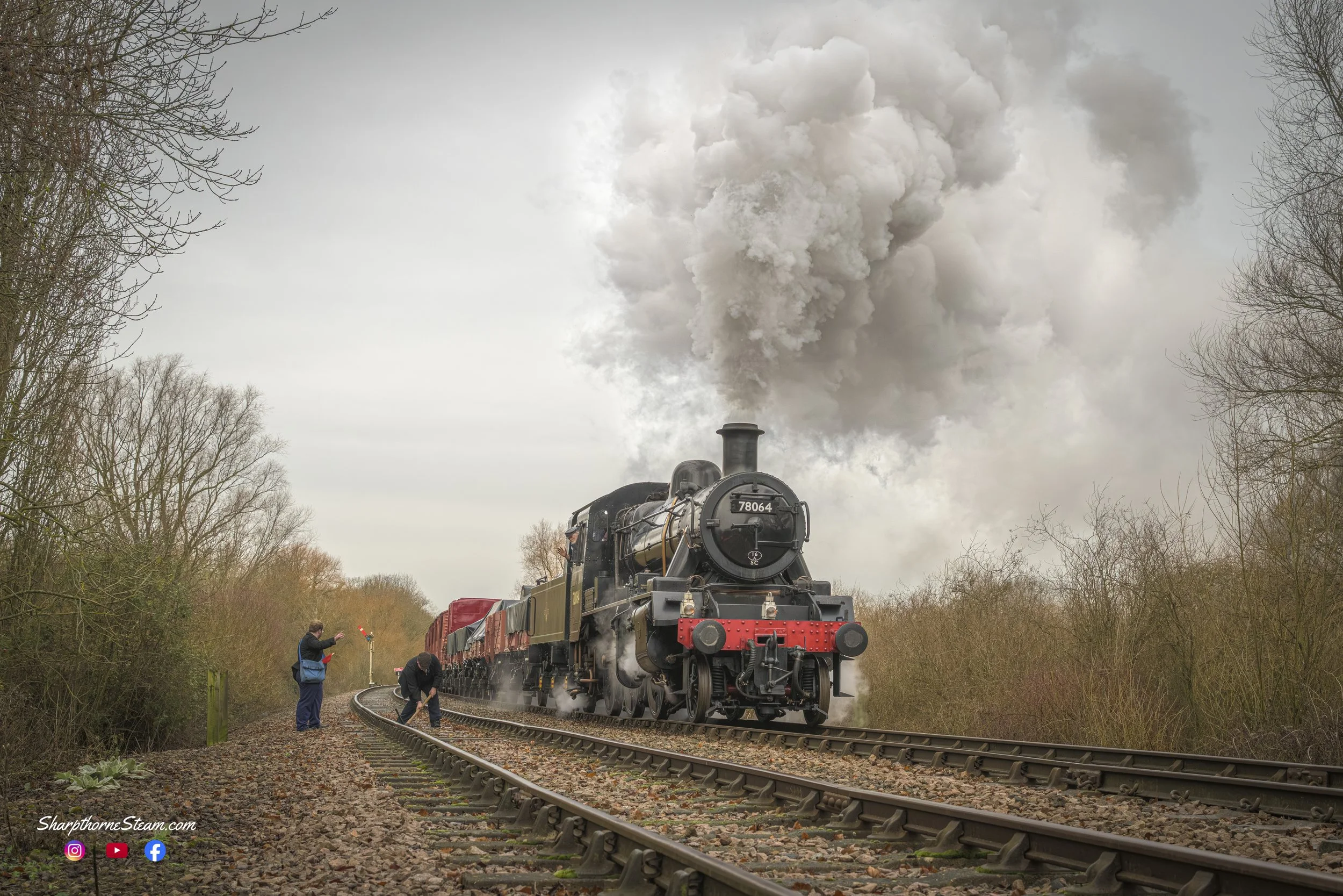 Emergency Repairs - Two members of the permanent way gang effects repairs as No78064 powers past on her way to Peterborough