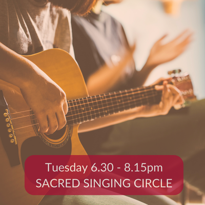 Person playing acoustic guitar with another clapping, promoting Sacred Singing Circle on Tuesday 6.30 - 8.15pm.