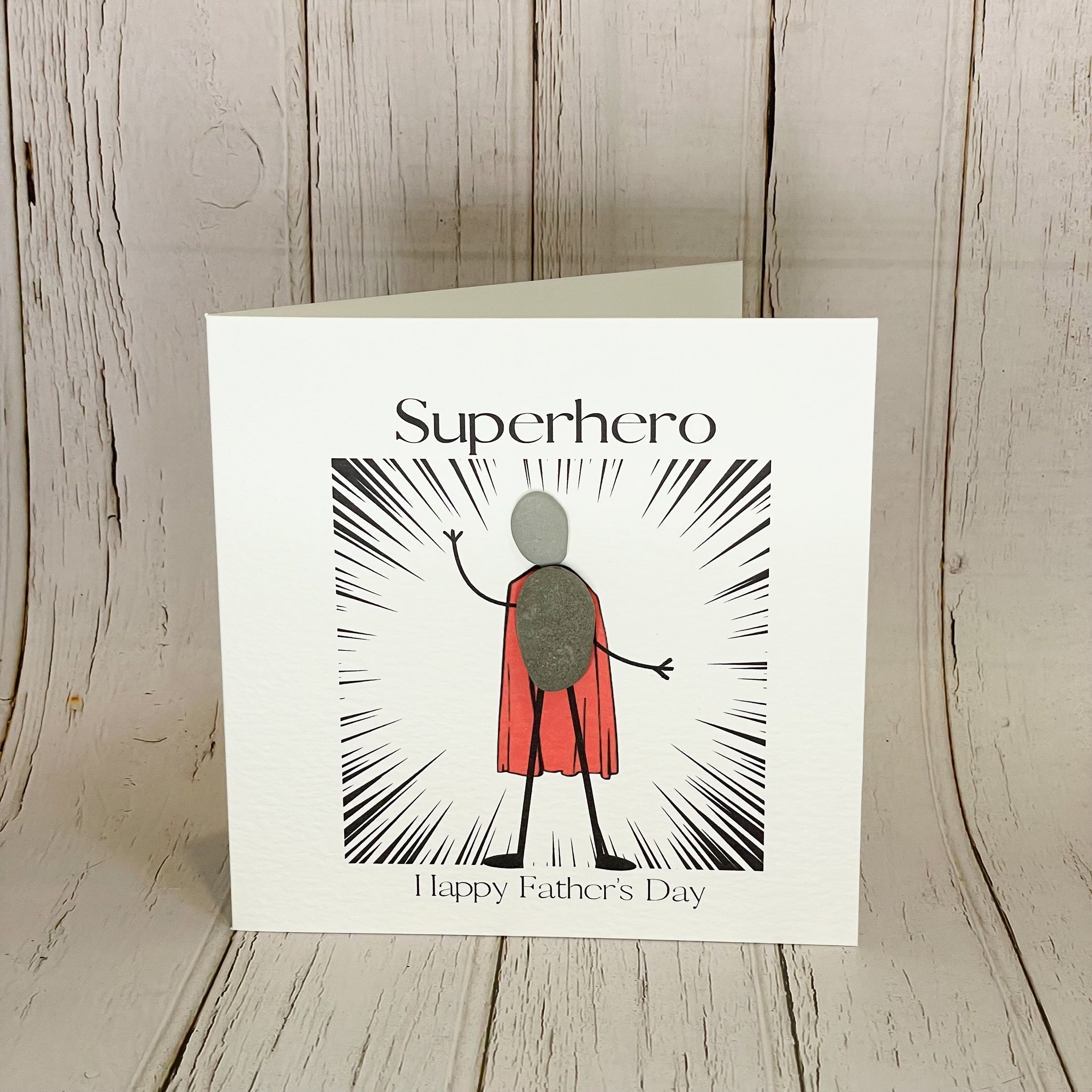 Handmade 6 x 6 inch Fathers Day card with superhero pebble art figure. Blank inside, on textured cardstock with envelope & cello wrap. Fun, thoughtful & unique.