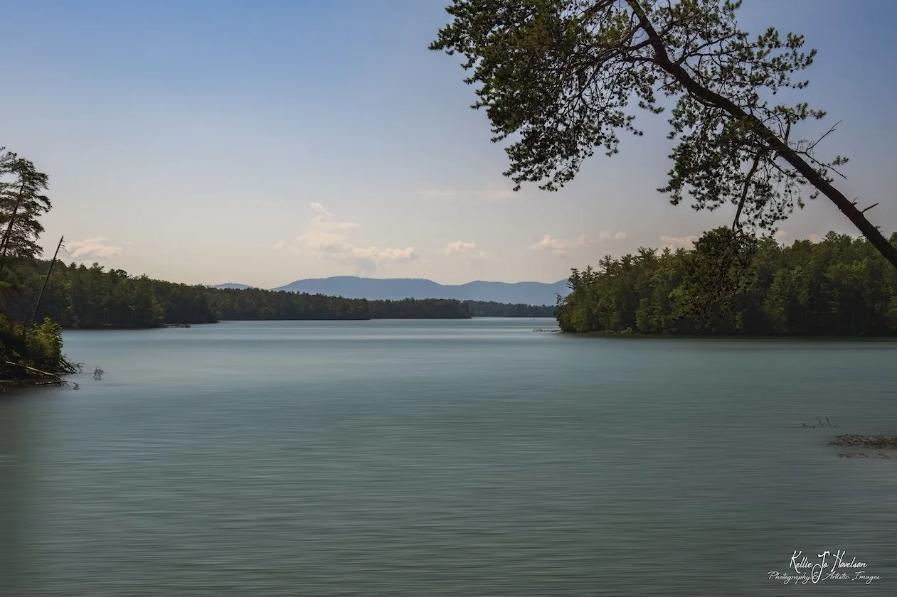 "Tranquil Lake with Distant Mountains"
