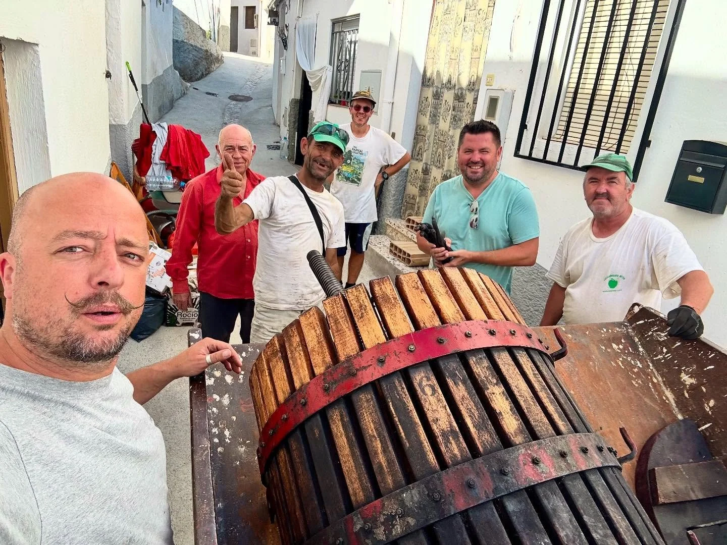 How many people does it take to move a wine press? Six apparently, and a dumper to move it. Heavy metal 😅