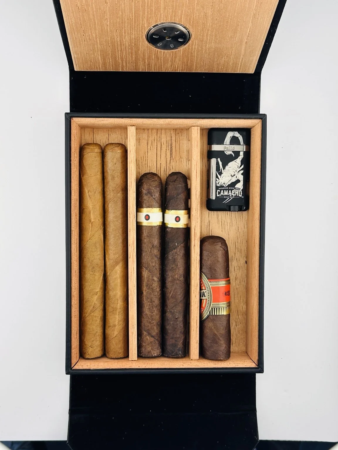 Heritage Box with Spanish cedar dividers separating cigars and a cigar cutter.