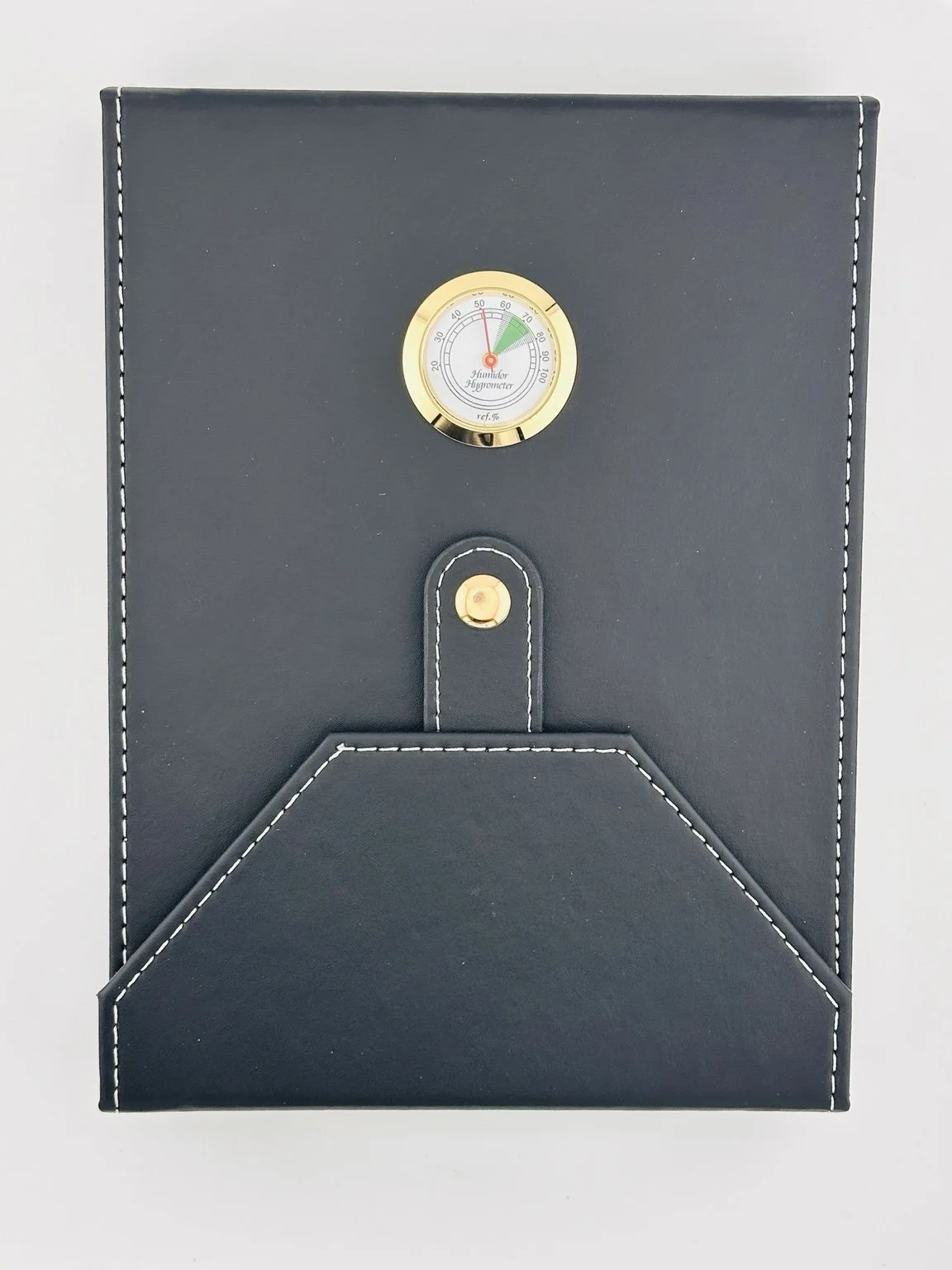 Heritage Box closed: black PU leather exterior with stitched edges and an analog hygrometer.