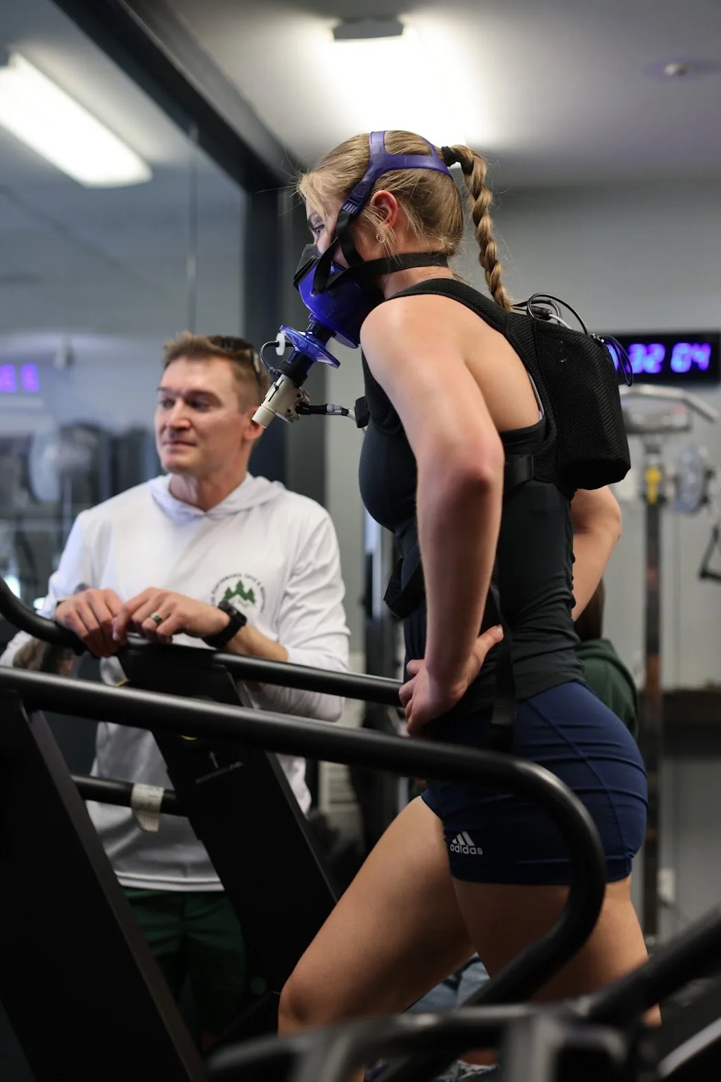A woman running on a treadmill doing a metabolic and vo2 max test