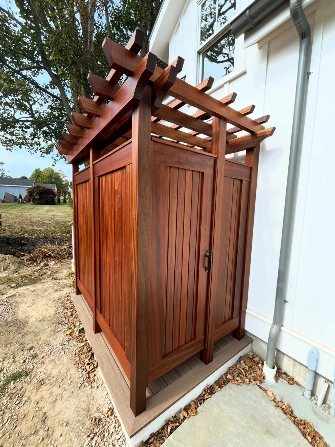 Not just an outdoor shower&mdash;this is a detail piece.

Custom-built with rich wood tones, clean vertical lines, and a pergola top that lets the light in just right. Designed to feel private, warm, and intentional&mdash;while still being fully expo
