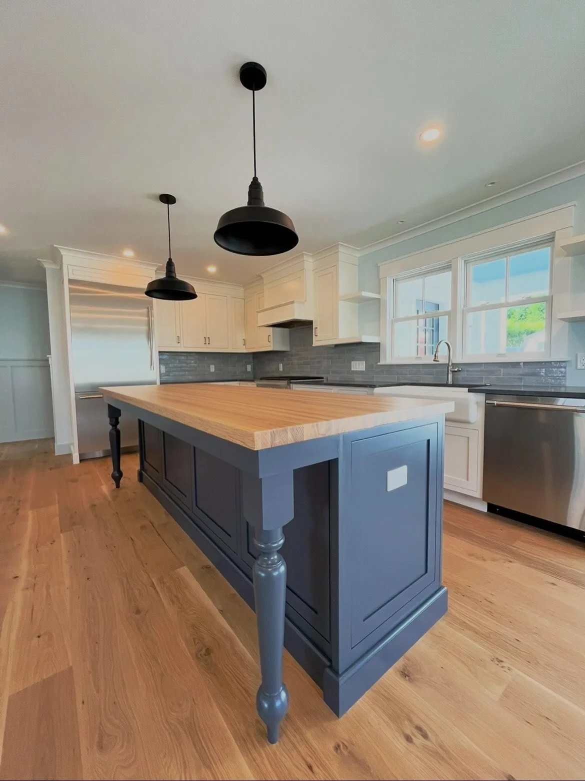 Designed to be the center of the home.

A clean, timeless kitchen anchored by a custom island, warm wood tones, and layered textures throughout.

From the contrast cabinetry to the handmade feel of the finishes, every detail was built with both funct