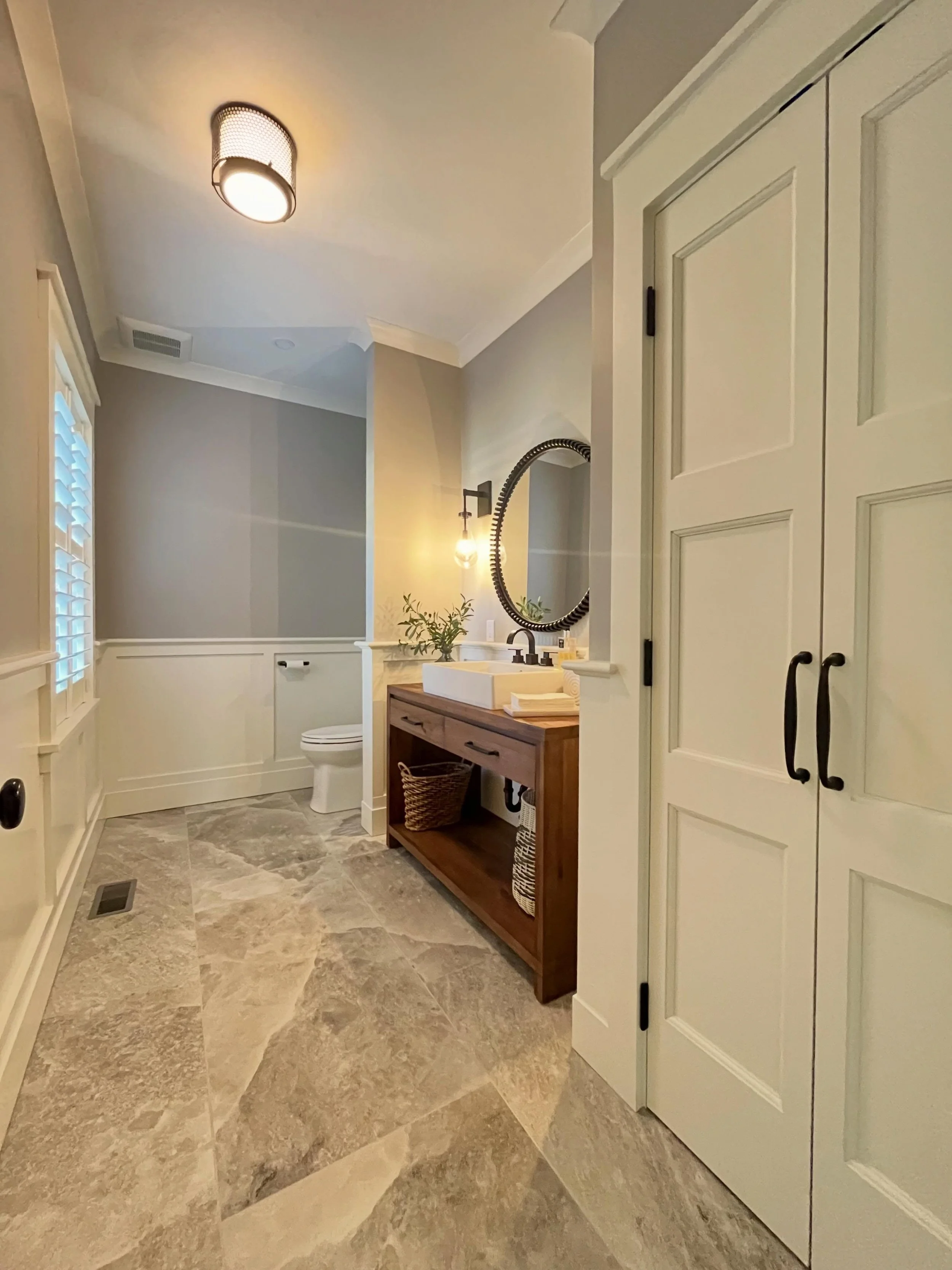 Warm wood tones, layered textures, custom trim work, and natural stone flooring come together to give this powder room just the right balance of character and simplicity.

Builder: @neillbros 
Architect: @dimauroarchitects 

#rhodeislandbuilder #cust