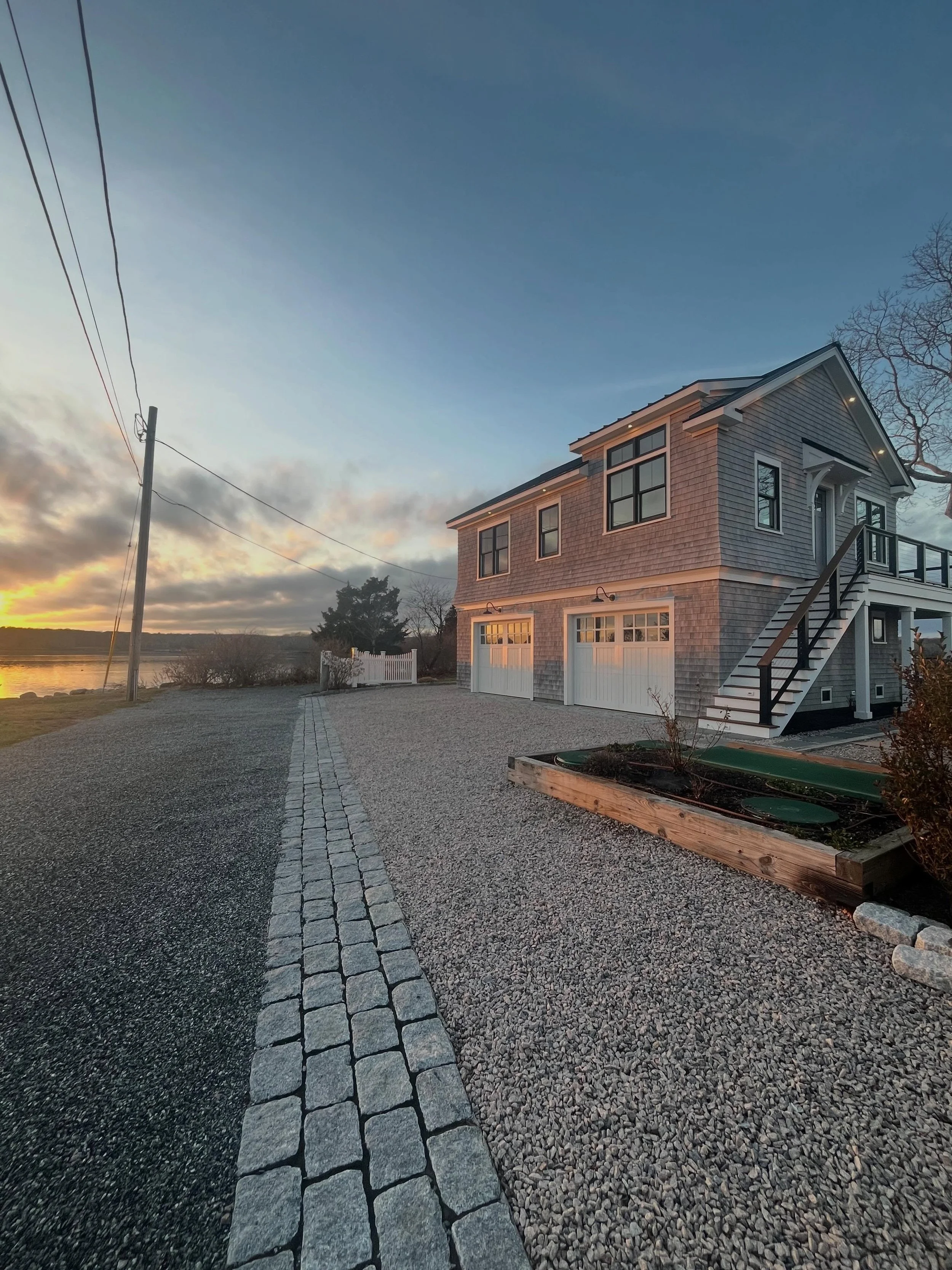 Designed to embrace the water, built to stand the test of time. From the cedar shingle exterior and elevated coastal architecture to the cable railings, custom entry details, and sweeping deck views &mdash; every line of this home was crafted with pu