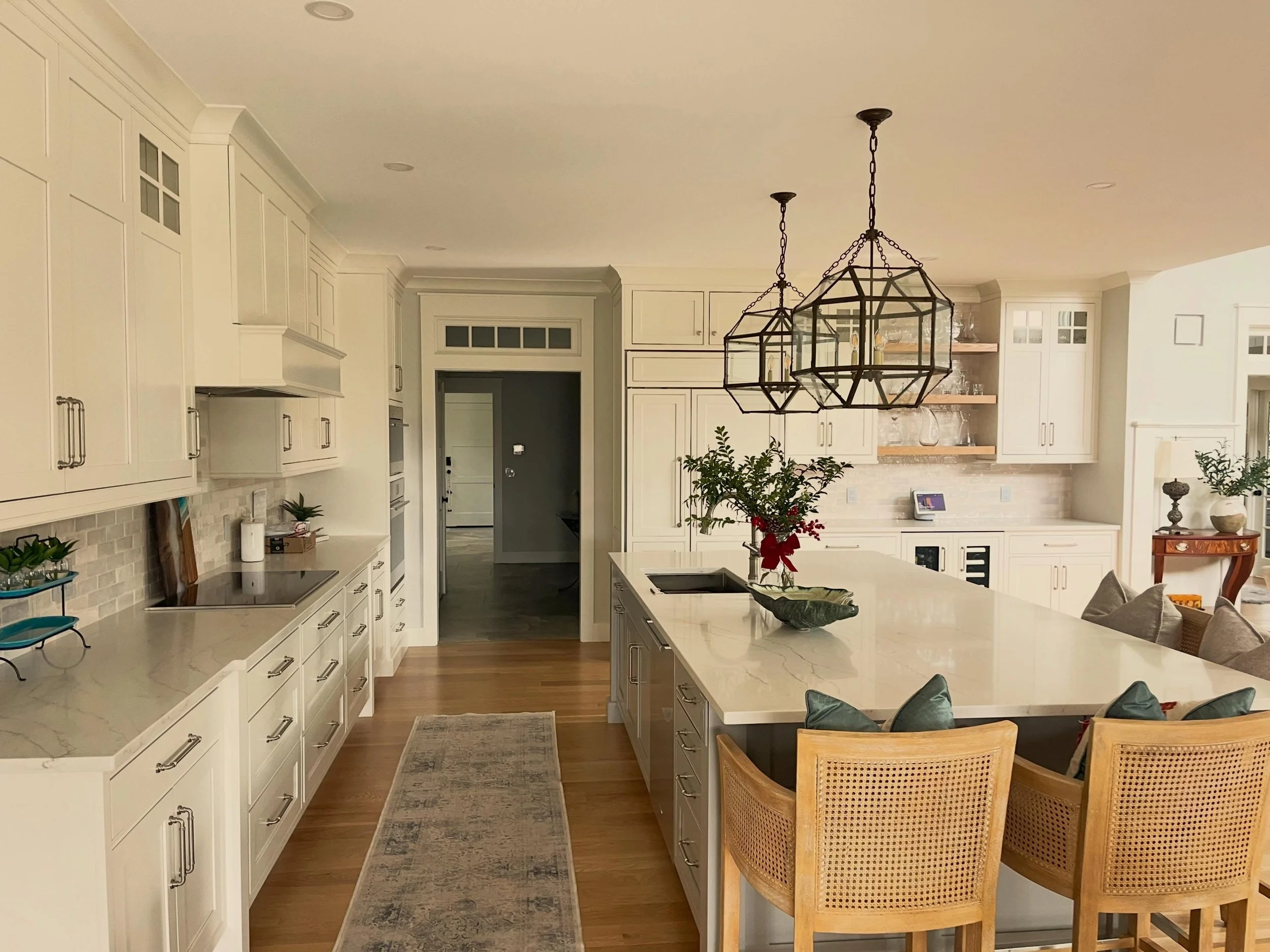 Clean lines, warm wood floors, and a kitchen designed around everyday living.

From the oversized island to the custom cabinetry and statement lanterns, every element was selected to balance beauty and practicality.

Builder: @neillbros 
Architect: @