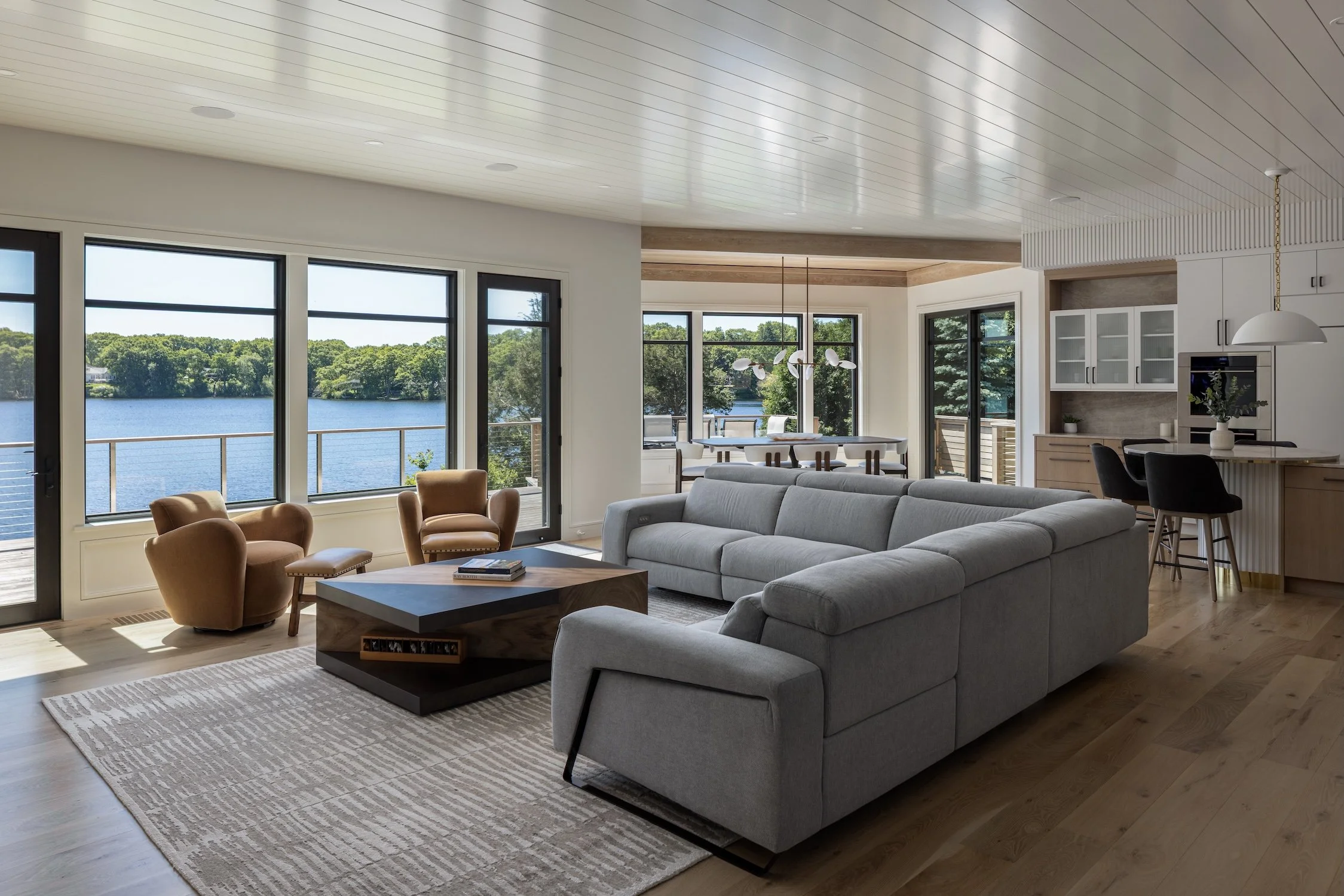 family room and kitchen, open concept living with water views, sectional couch, seating