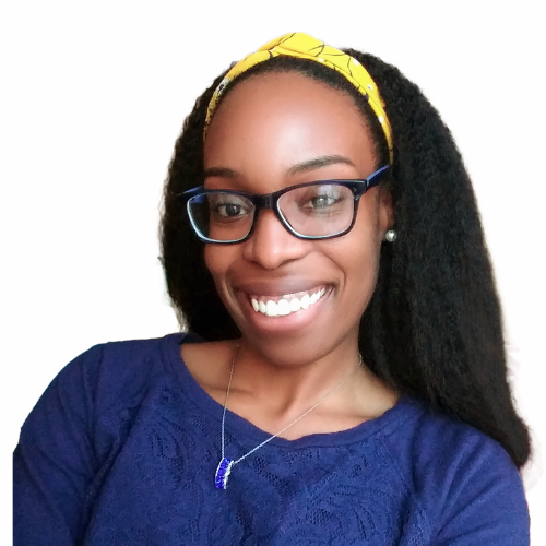 A woman with dark hair wearing glasses, a yellow headband, a blue top, and a necklace, smiling at the camera.